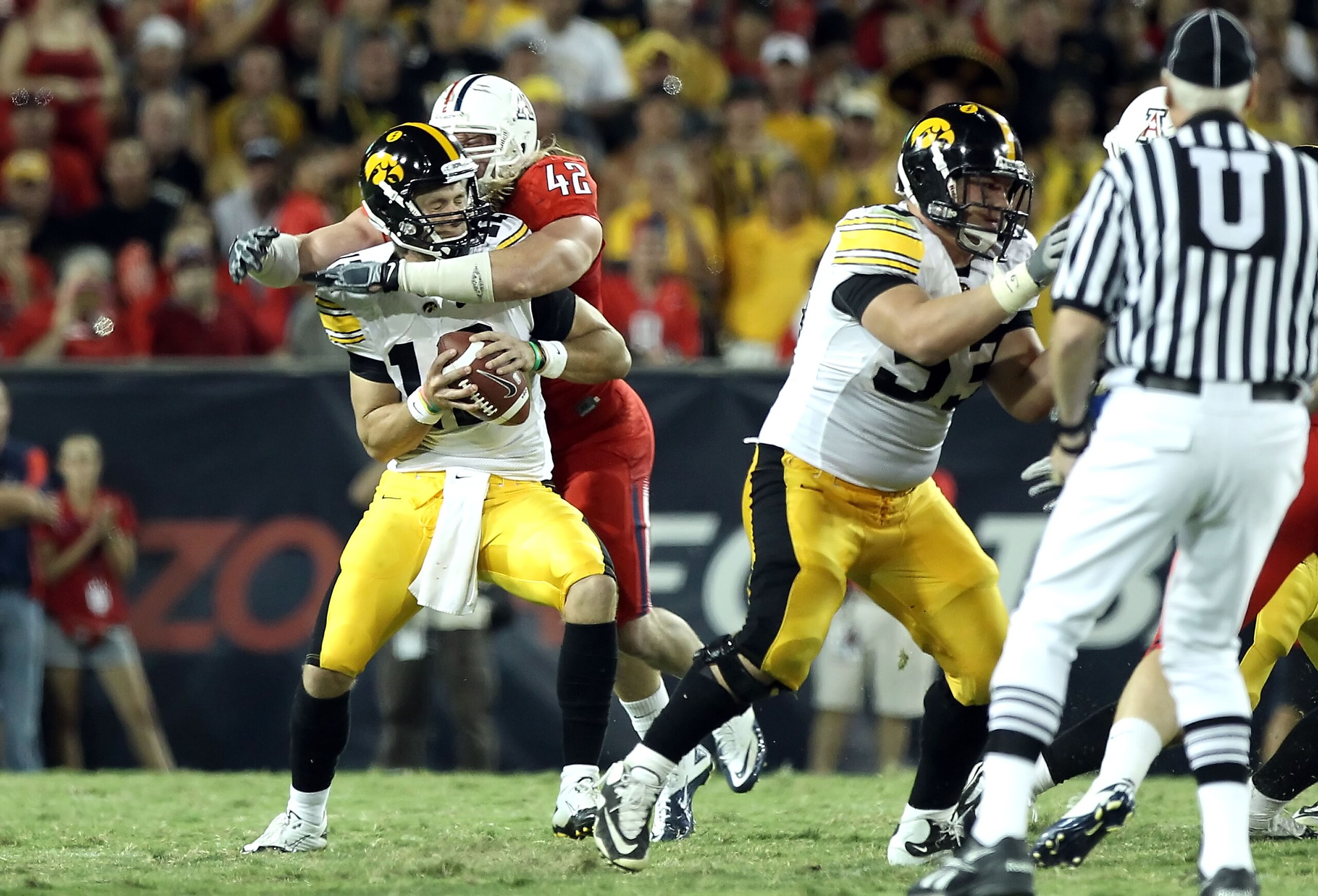 TUCSON, AZ - SEPTEMBER 18: Quarterback Ricky Stanzi #12 of the Iowa Hawkeyes is sacked by Brooks Reed #42 of the Arizona Wildcats during the third quarter of the college football game at Arizona Stadium on September 18, 2010 in Tucson, Arizona. The Wild TUCSON, AZ - SEPTEMBER 18: Quarterback Ricky Stanzi #12 of the Iowa Hawkeyes is sacked by Brooks Reed #42 of the Arizona Wildcats during the third quarter of the college football game at Arizona Stadium on September 18, 2010 in Tucson, Arizona. The Wild