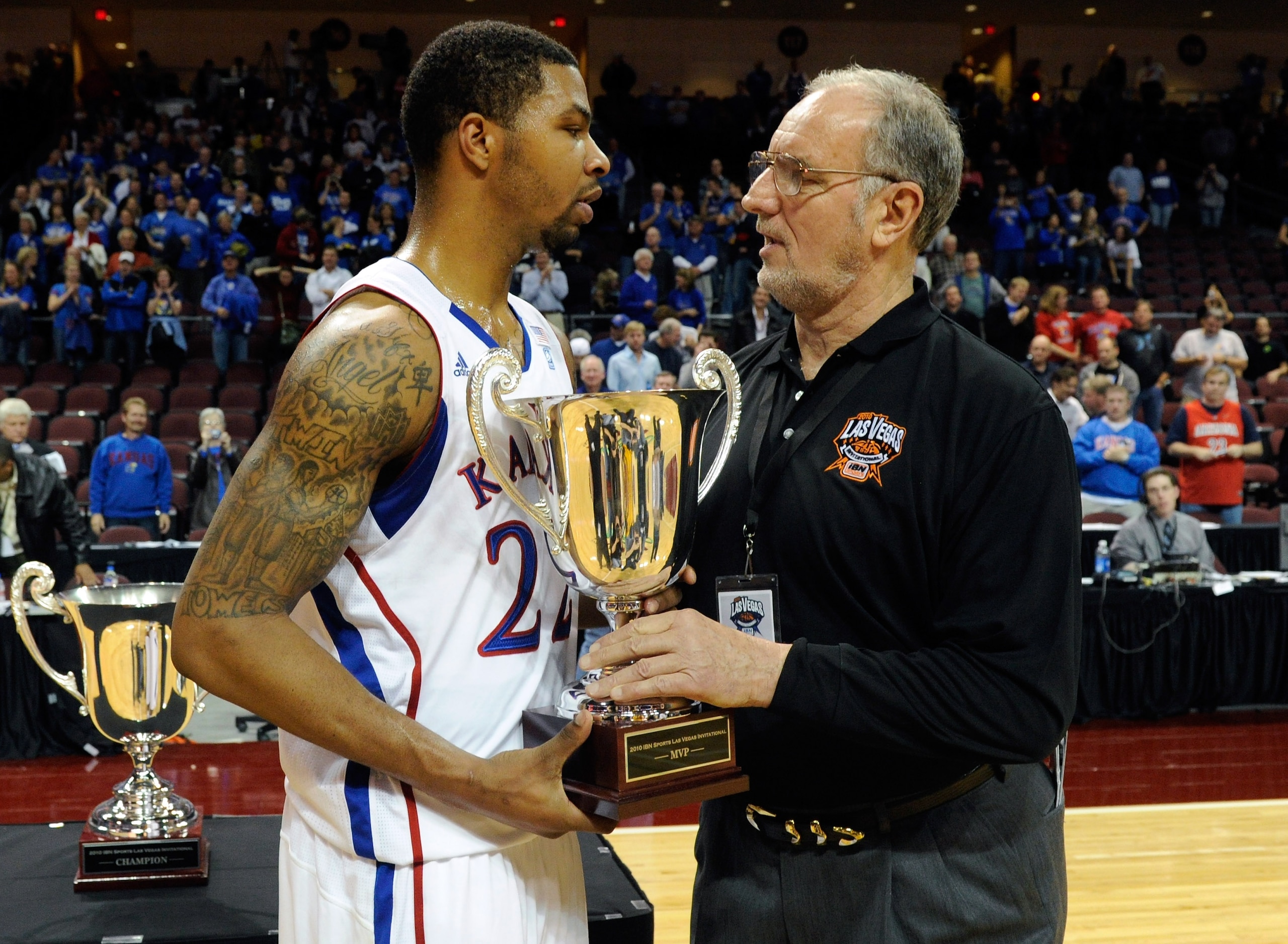 LAS VEGAS - NOVEMBER 27:  Marcus Morris #22 of the Kansas Jayhawks receives the MVP trophy from tournament dirctor Bob Patton after Kansas defeated the Arizona Wildcats 87-79 in the championship game of the Las Vegas Invitational at The Orleans Arena Nove