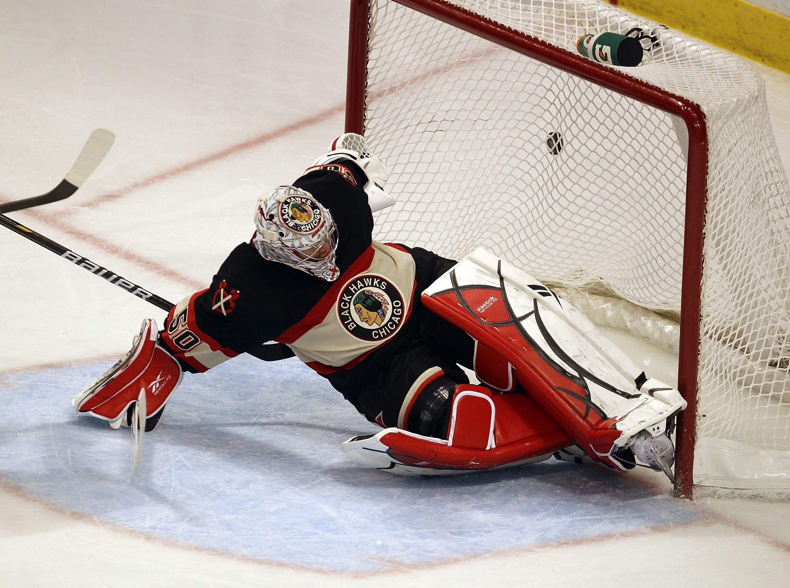 CHICAGO, IL - JANUARY 25: Corey Crawford #50 of the Chicago Blackhawks dives to stop the puck against the Minnesota Wild at the United Center on January 25, 2011 in Chicago, Illinois. The Wild defeated the Blackhawks 4-2. (Photo by Jonathan Daniel/Getty I
