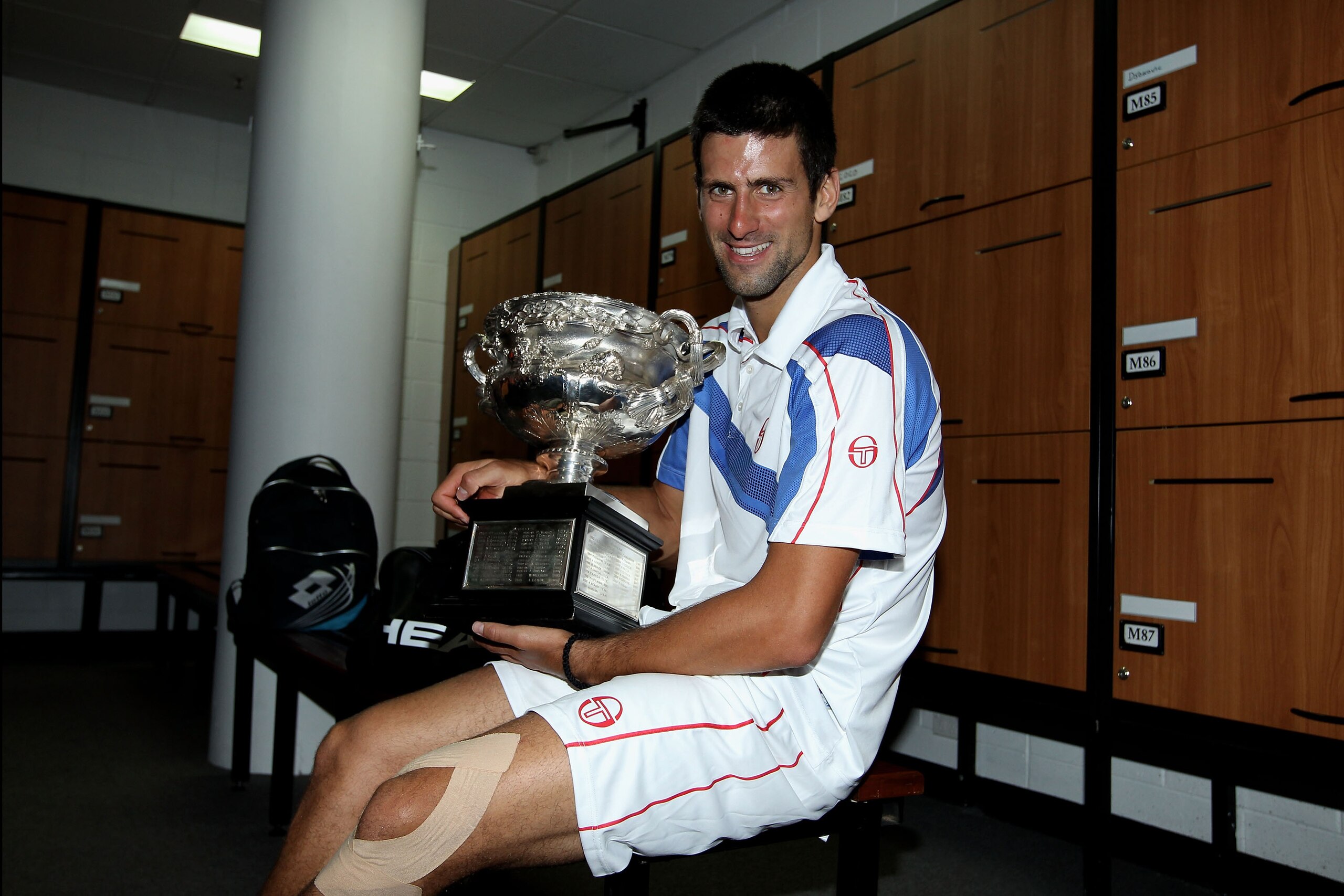 MELBOURNE, AUSTRALIA - JANUARY 30:  Novak Djokovic of Serbia poses with the Norman Brookes Challenge Cup in the players locker room after winning the men's final match against Andy Murray of Great Britain during day fourteen of the 2011 Australian Open at