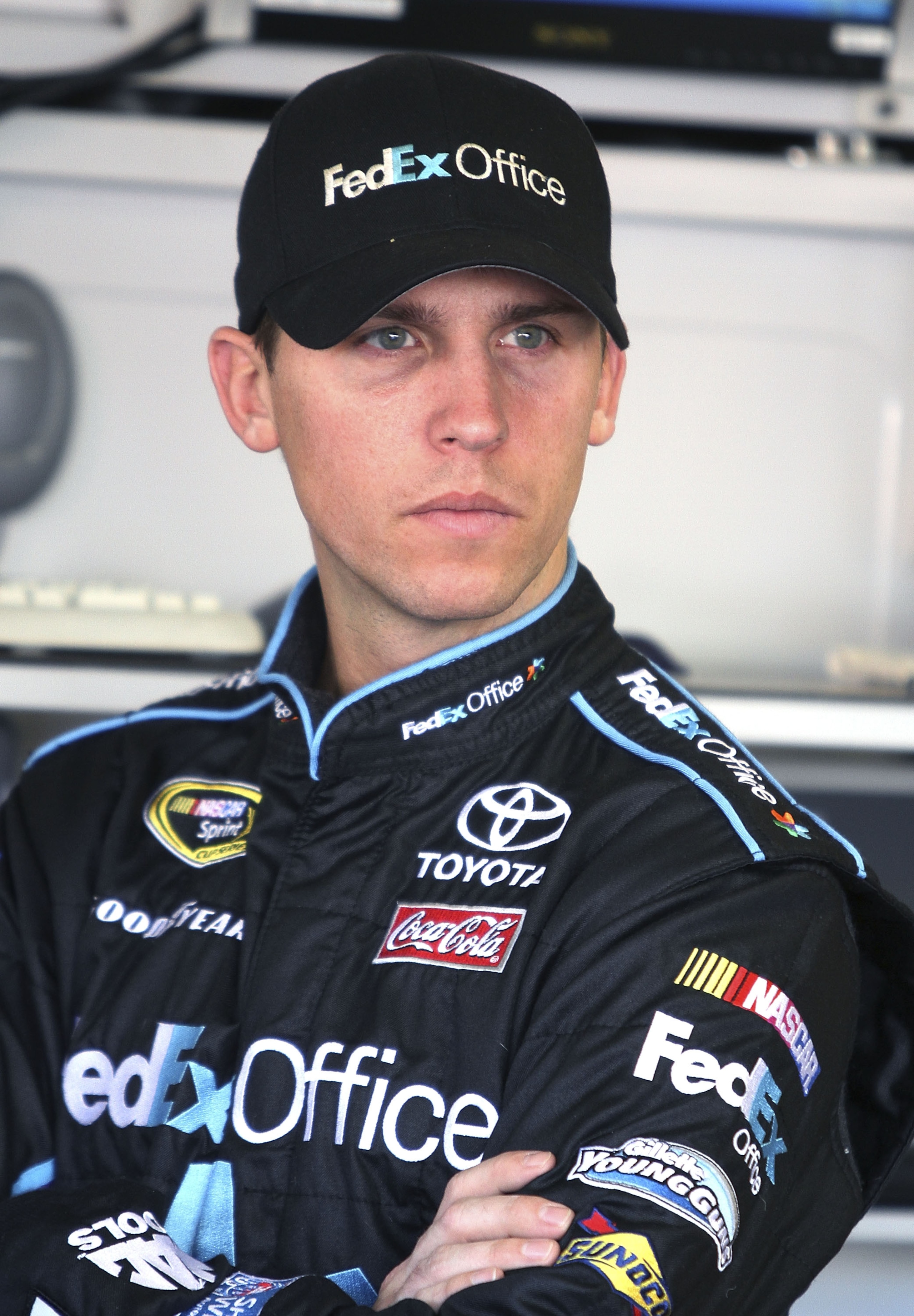 DAYTONA BEACH, FL - JANUARY 20:  Denny Hamlin, driver of the #11 FedEx Toyota waits in the garage during testing at Daytona International Speedway on January 20, 2011 in Daytona Beach, Florida.  (Photo by Jerry Markland/Getty Images for NASCAR)
