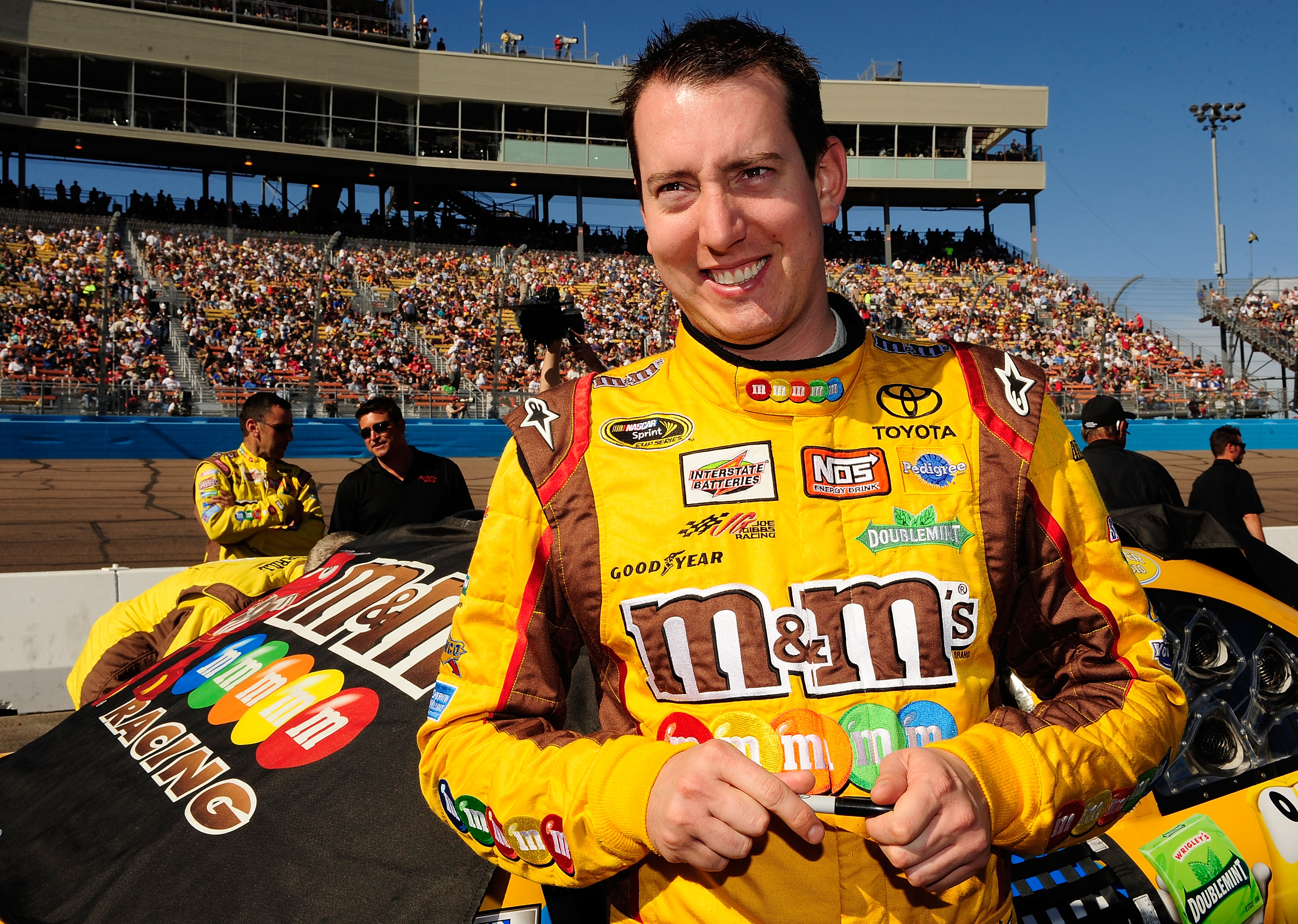 AVONDALE, AZ - NOVEMBER 14:  Kyle Busch, driver of the #18 M&M'sToyota, stands by his car prior to the NASCAR Sprint Cup Series Kobalt Tools 500 at Phoenix International Raceway on November 14, 2010 in Avondale, Arizona.  (Photo by Rusty Jarrett/Getty Ima