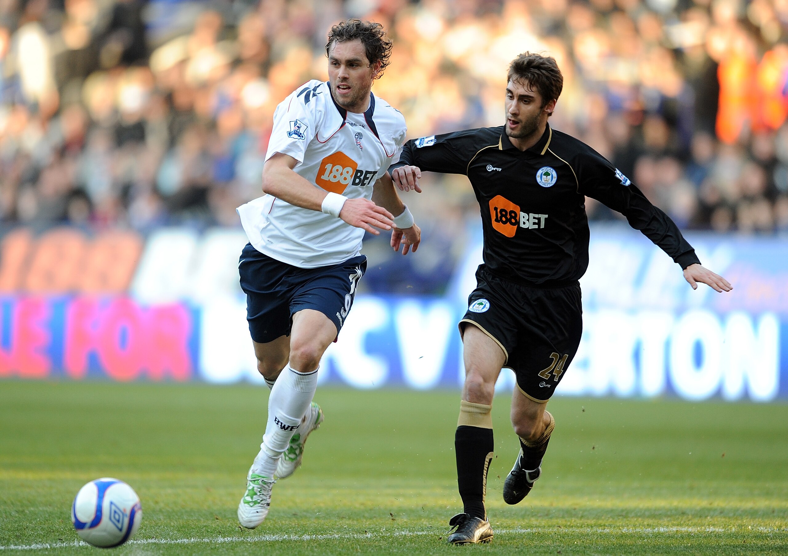 BOLTON, ENGLAND - JANUARY 29: Johan Elmander of Bolton Wanderers competes with Adrian Lopez of Wigan Athletic during the FA Cup sponsored by E.ON 4th Round match between Bolton Wanderers and Wigan Athletic at the Reebok Stadium on January 29, 2011 in Bolt