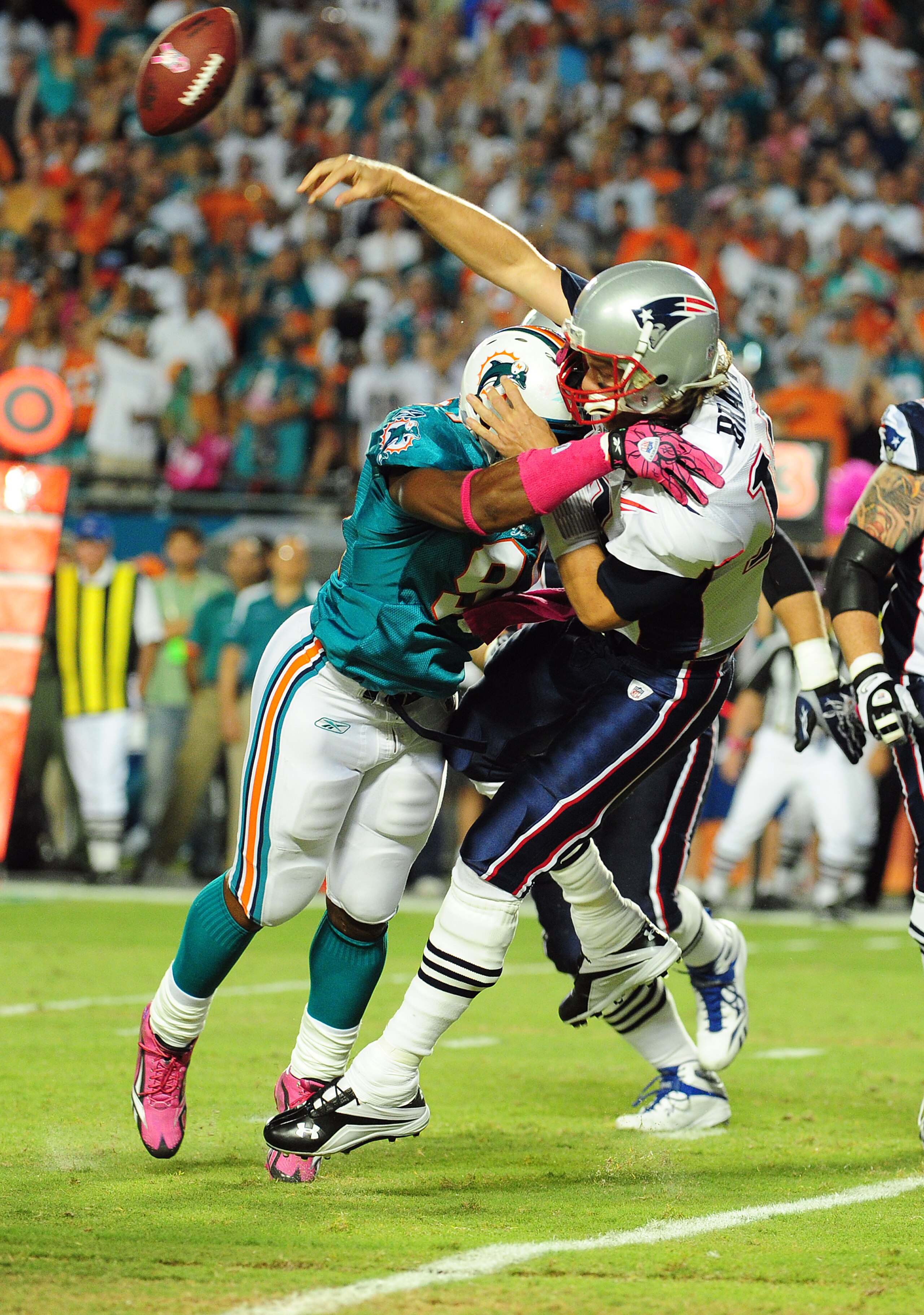 MIAMI - OCTOBER 4: Tom Brady #12 of the New England Patriots is hit as he passes by Cameron Wake #91 of the Miami Dolphins at Sun Life Field on October 4, 2010 in Miami, Florida. (Photo by Scott Cunningham/Getty Images) MIAMI - OCTOBER 4: Tom Brady #12 of the New England Patriots is hit as he passes by Cameron Wake #91 of the Miami Dolphins at Sun Life Field on October 4, 2010 in Miami, Florida. (Photo by Scott Cunningham/Getty Images)
