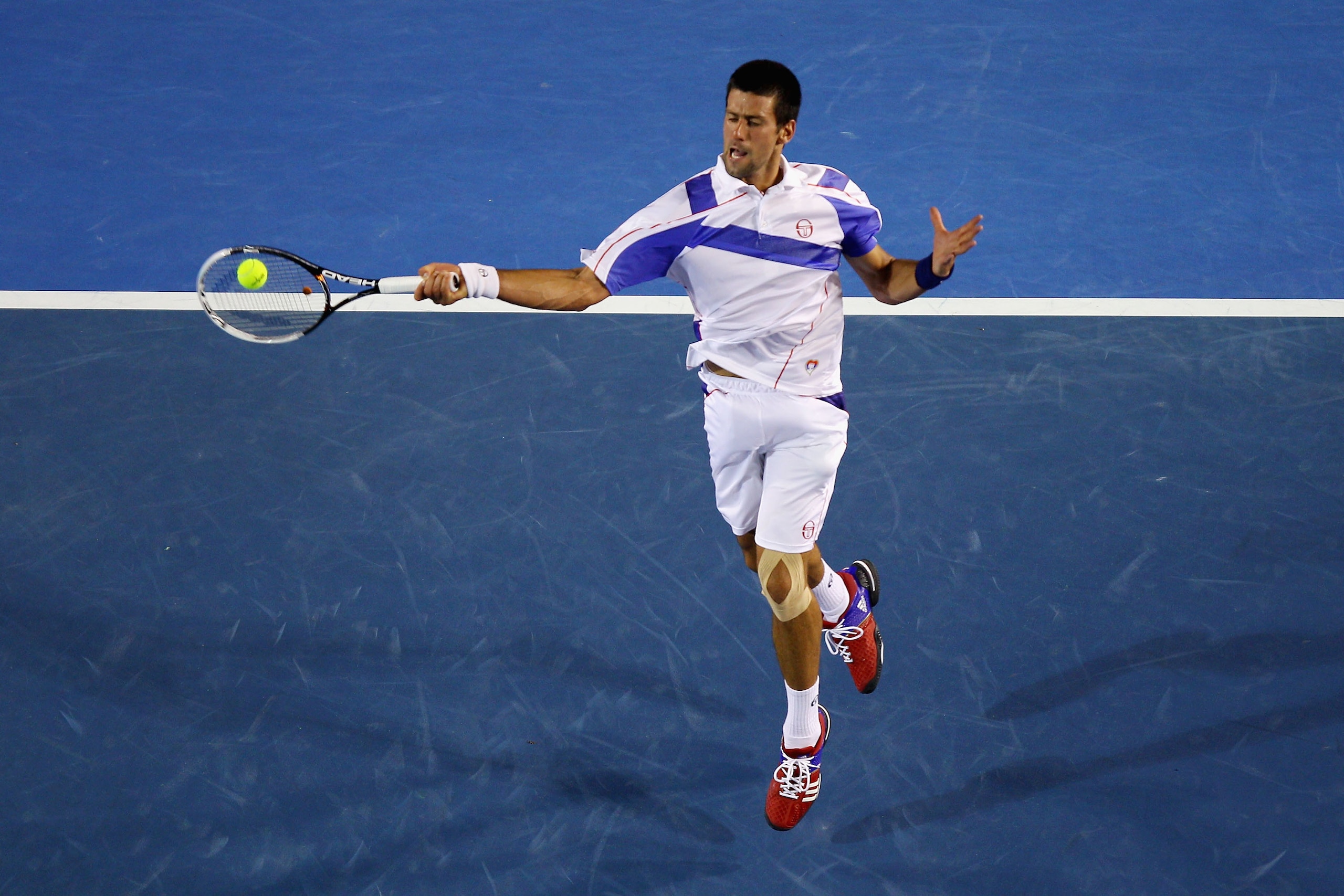 MELBOURNE, AUSTRALIA - JANUARY 30:  Novak Djokovic of Serbia plays a forehand in his men's final match against Andy Murray of Great Britain during day fourteen of the 2011 Australian Open at Melbourne Park on January 30, 2011 in Melbourne, Australia.  (Ph