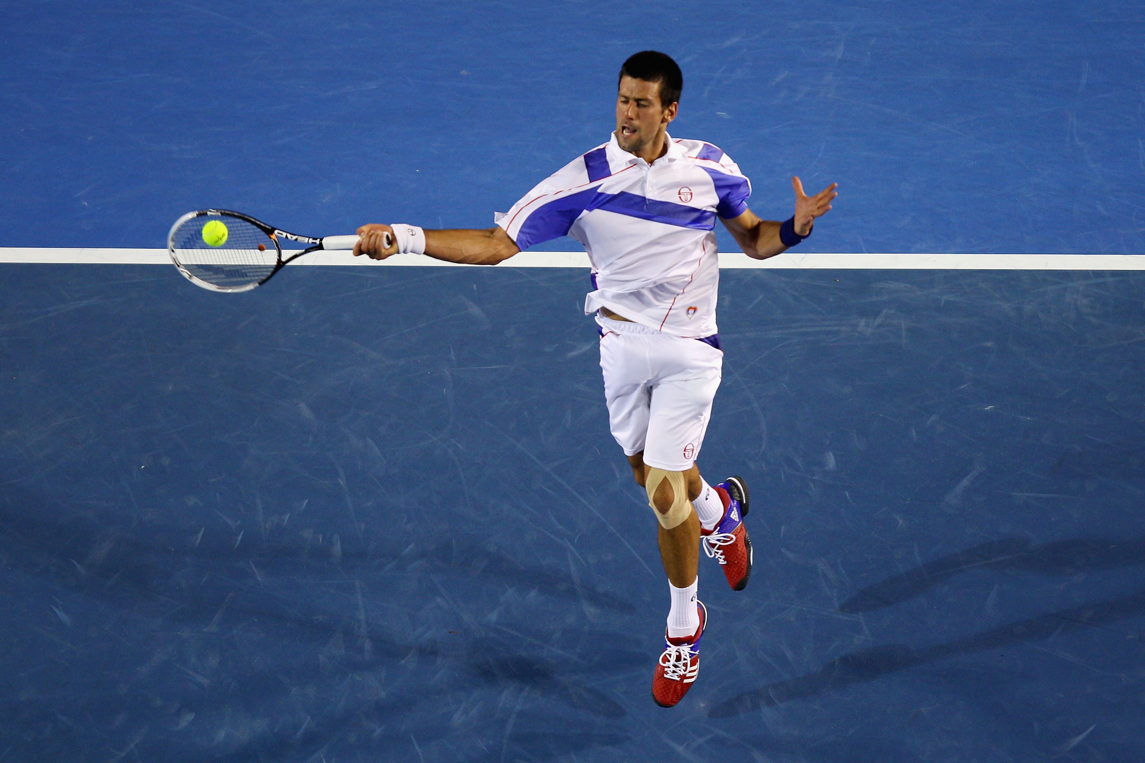 MELBOURNE, AUSTRALIA - JANUARY 30:  Novak Djokovic of Serbia plays a forehand in his men's final match against Andy Murray of Great Britain during day fourteen of the 2011 Australian Open at Melbourne Park on January 30, 2011 in Melbourne, Australia.  (Ph