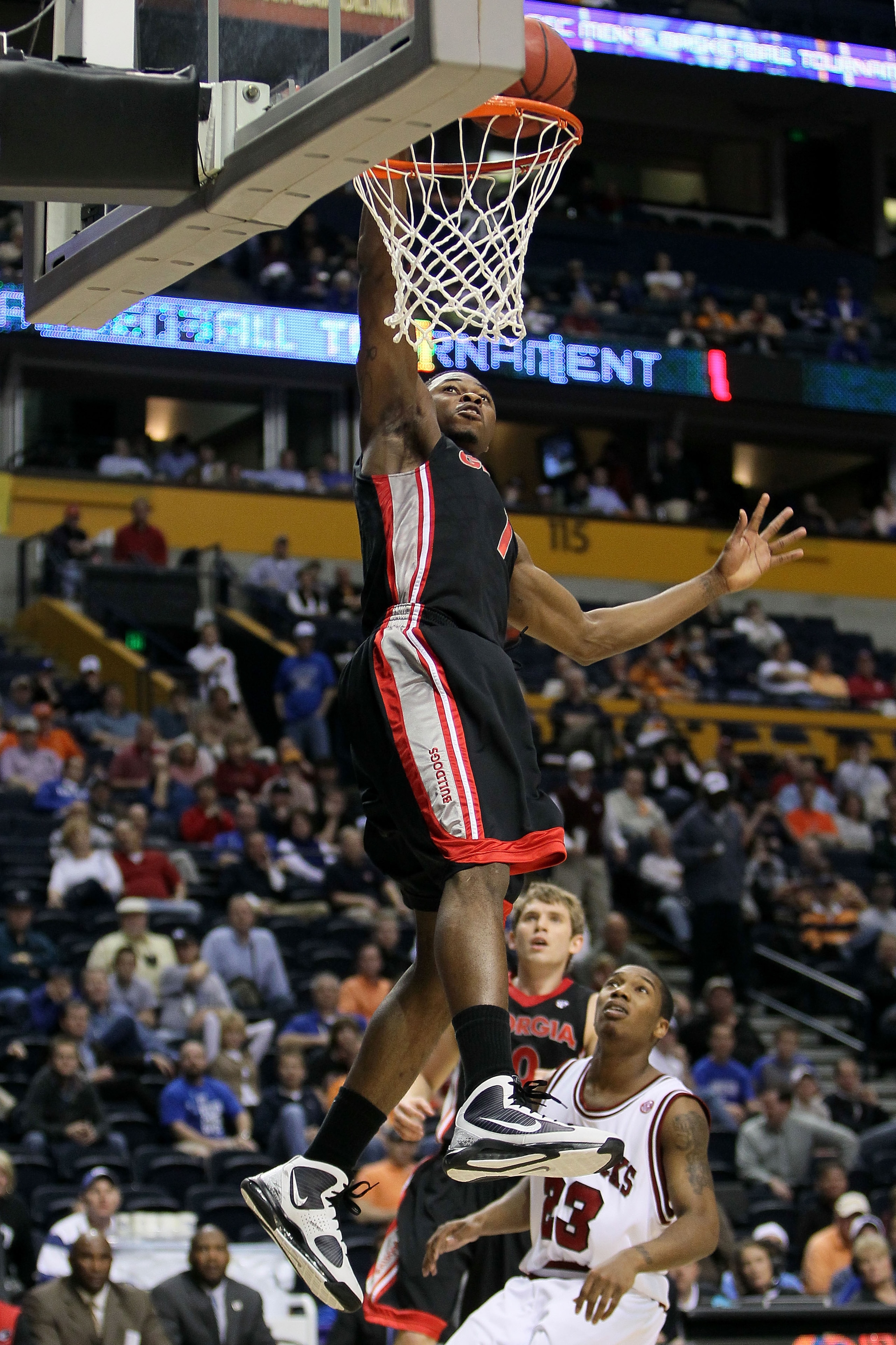 NASHVILLE, TN - MARCH 11: Travis Leslie #1 of the Georgia Bulldogs goes up for a dunk attempt against Julysses Nobles #23 of the Arkanasas Razorbacks during the first round of the SEC Men's Basketball Tournament at the Bridgestone Arena on March 11, 2010 NASHVILLE, TN - MARCH 11: Travis Leslie #1 of the Georgia Bulldogs goes up for a dunk attempt against Julysses Nobles #23 of the Arkanasas Razorbacks during the first round of the SEC Men's Basketball Tournament at the Bridgestone Arena on March 11, 2010