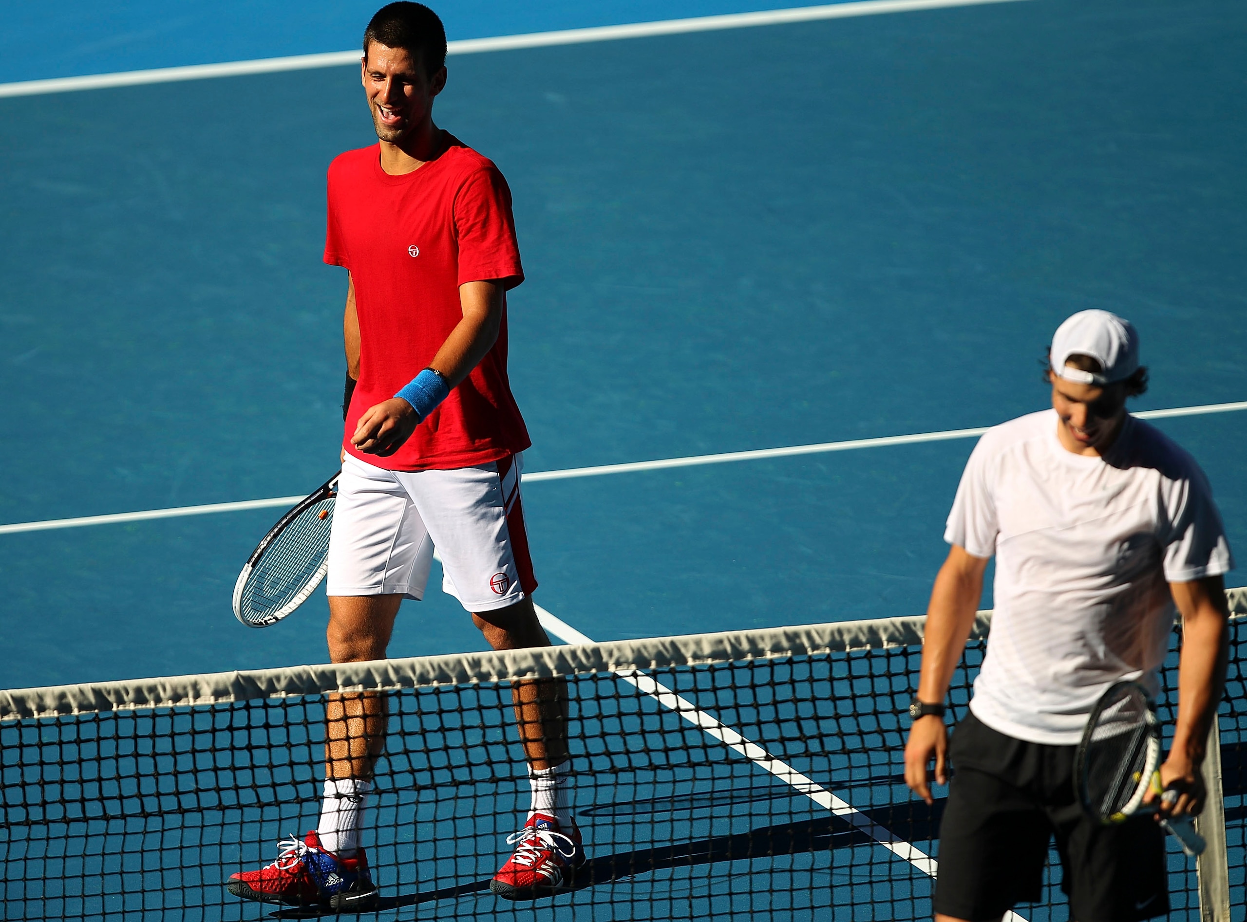 MELBOURNE, AUSTRALIA - JANUARY 14:  Novak Djokovic of Serbia and Rafael Nadal train together during a practice session ahead of the 2011 Australian Open at Melbourne Park on January 14, 2011 in Melbourne, Australia.  (Photo by Lucas Dawson/Getty Images)