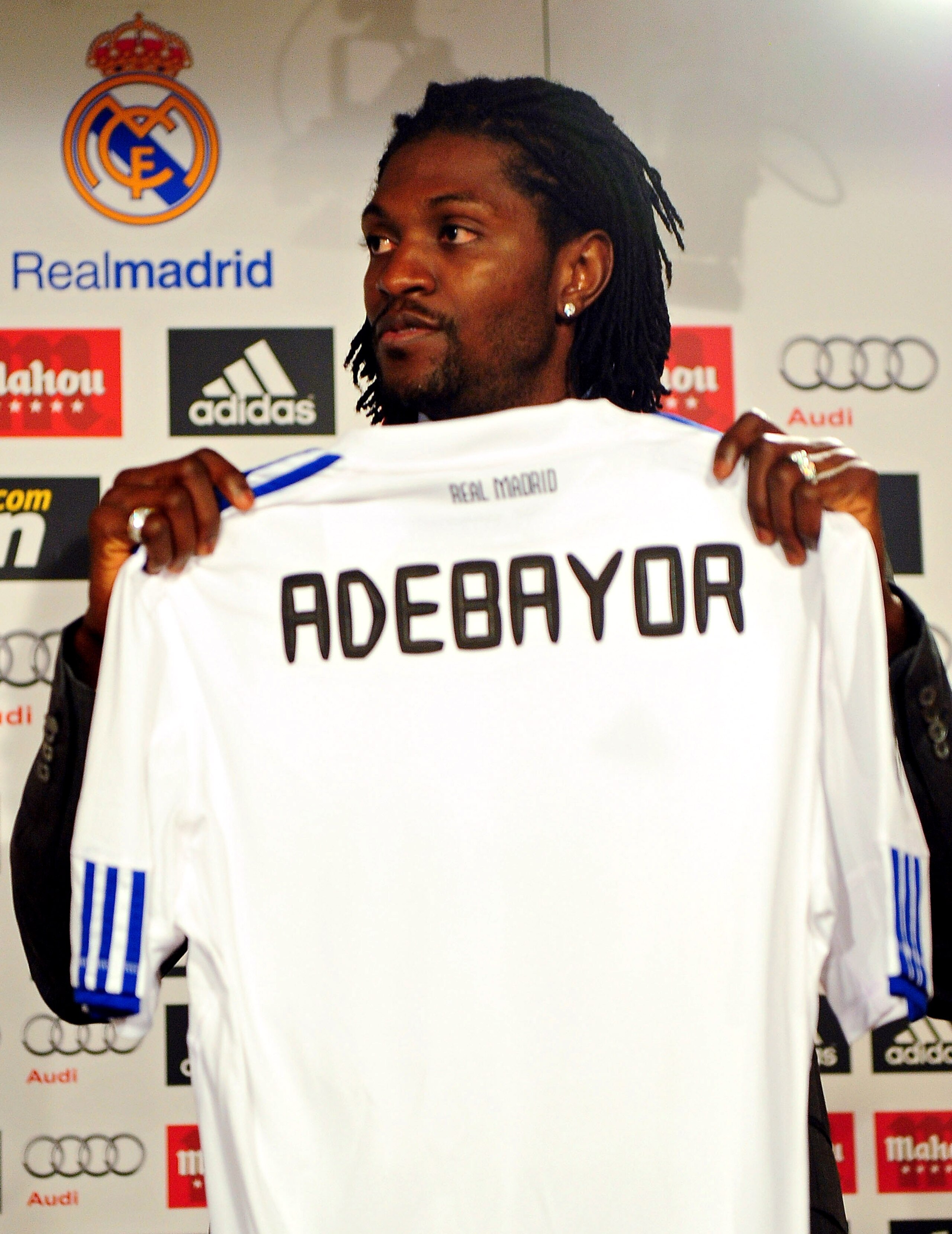 MADRID, SPAIN - JANUARY 27:  Emmanuel Adebayor holds up his new Real Madrid shirt during his presentation as a new Real Madrid player at Estadio Santiago Bernabeu on January 27, 2011 in Madrid, Spain.  (Photo by Denis Doyle/Getty Images)