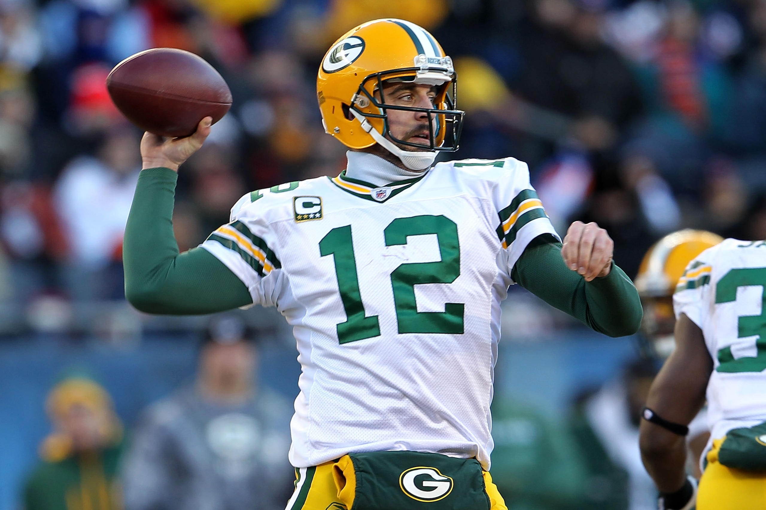 CHICAGO, IL - JANUARY 23:  Quarterback Aaron Rodgers #12 of the Green Bay Packers looks to pass against the Chicago Bears in the NFC Championship Game at Soldier Field on January 23, 2011 in Chicago, Illinois.  (Photo by Jamie Squire/Getty Images)