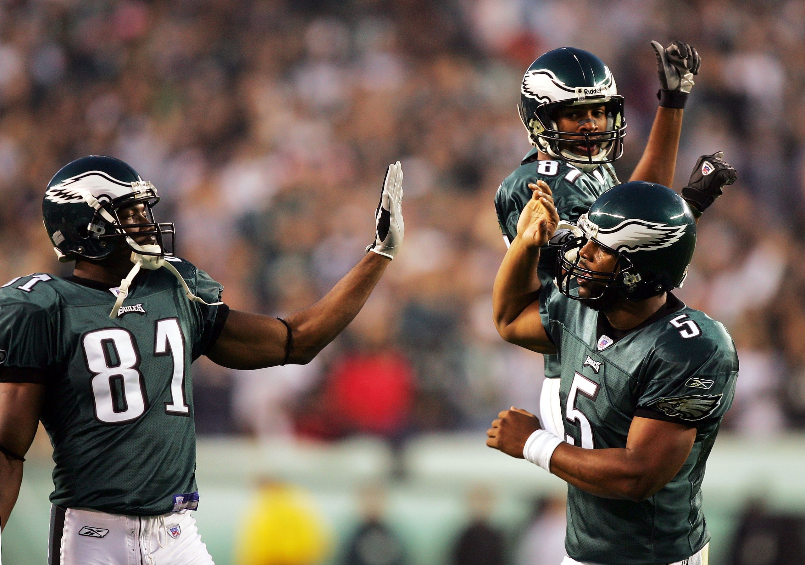PHILADELPHIA - NOVEMBER 21:  Donovan McNabb #5 of the Philadelphia Eagles is congratulated by teammates Terrell Owens #81 and Todd Pinkston #87 after McNabb threw a touchdown pass to Chad Lewis against the Washington Redskins on November 21, 2004 at Linco