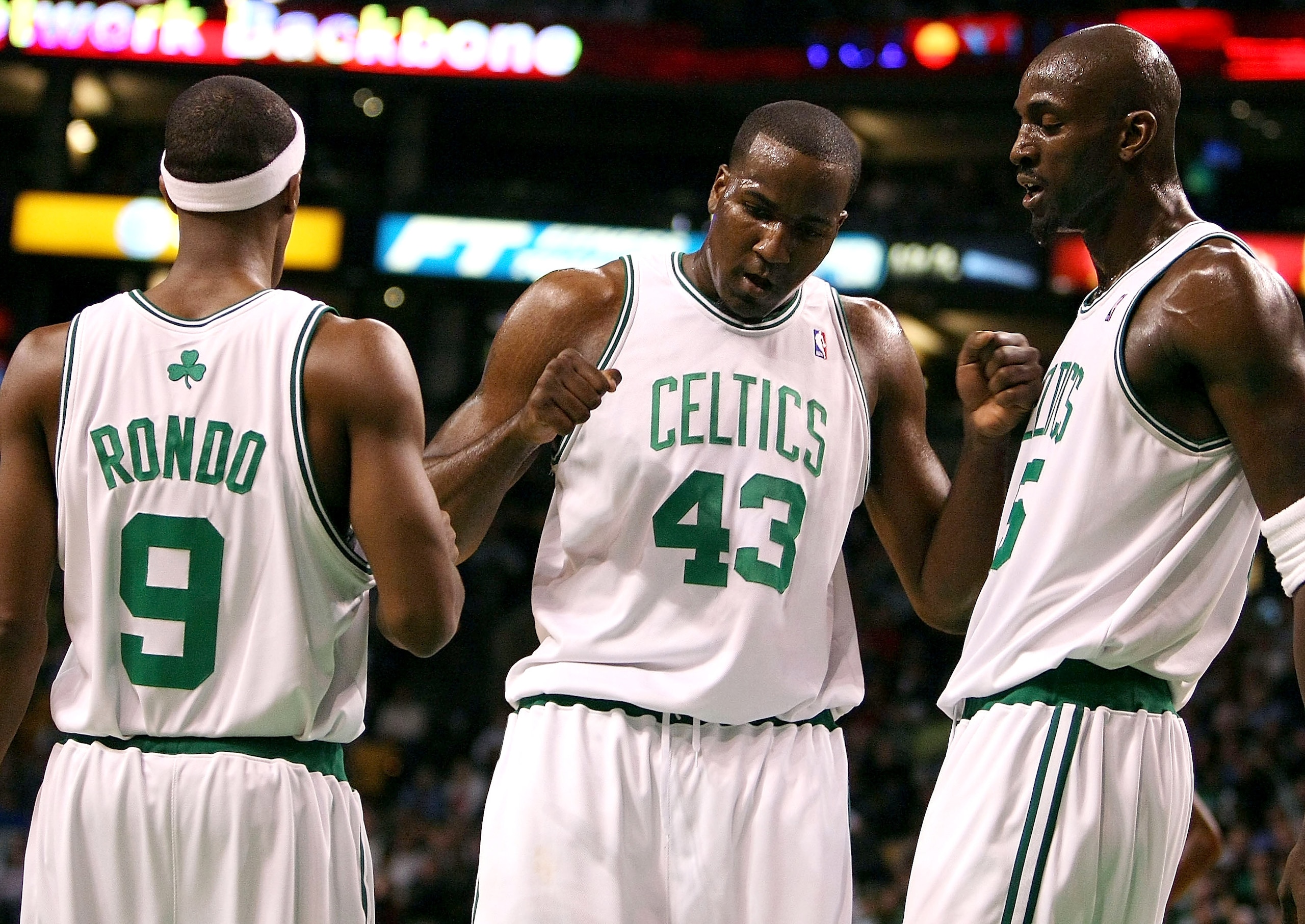 BOSTON - NOVEMBER 26: Kendrick Perkins #43 of the Boston Celtics is congratulated by teammates Kevin Garnett #5 and Rajon Rondo #9 after Perkins make a free throw in the first quarter against the Golden State Warriors on November 26,2008 at TD Banknorth G
