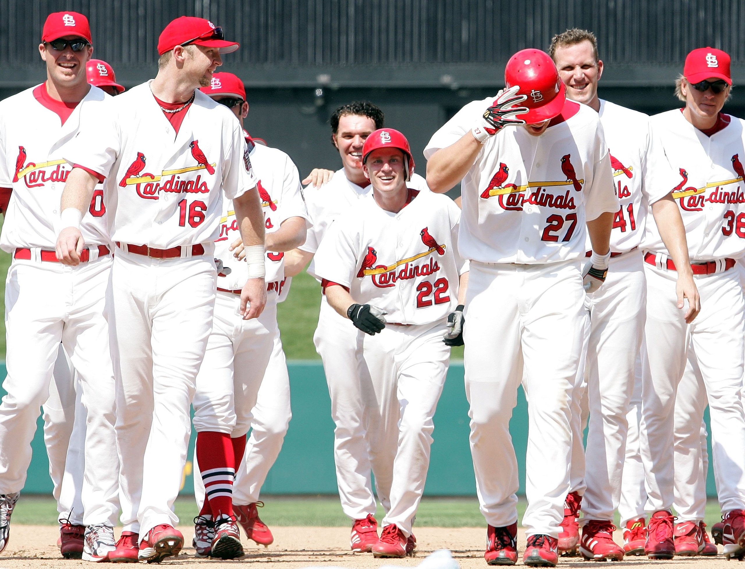 ST. LOUIS - JULY 15:  Scott Rolen #27 of the St. Louis Cardinals is congratulated by teammates after he hit a game-winning RBI single to drive in David Eckstein #22 in the bottom of the 10th inning against the Los Angeles Dodgers on July 15, 2006 at Busch
