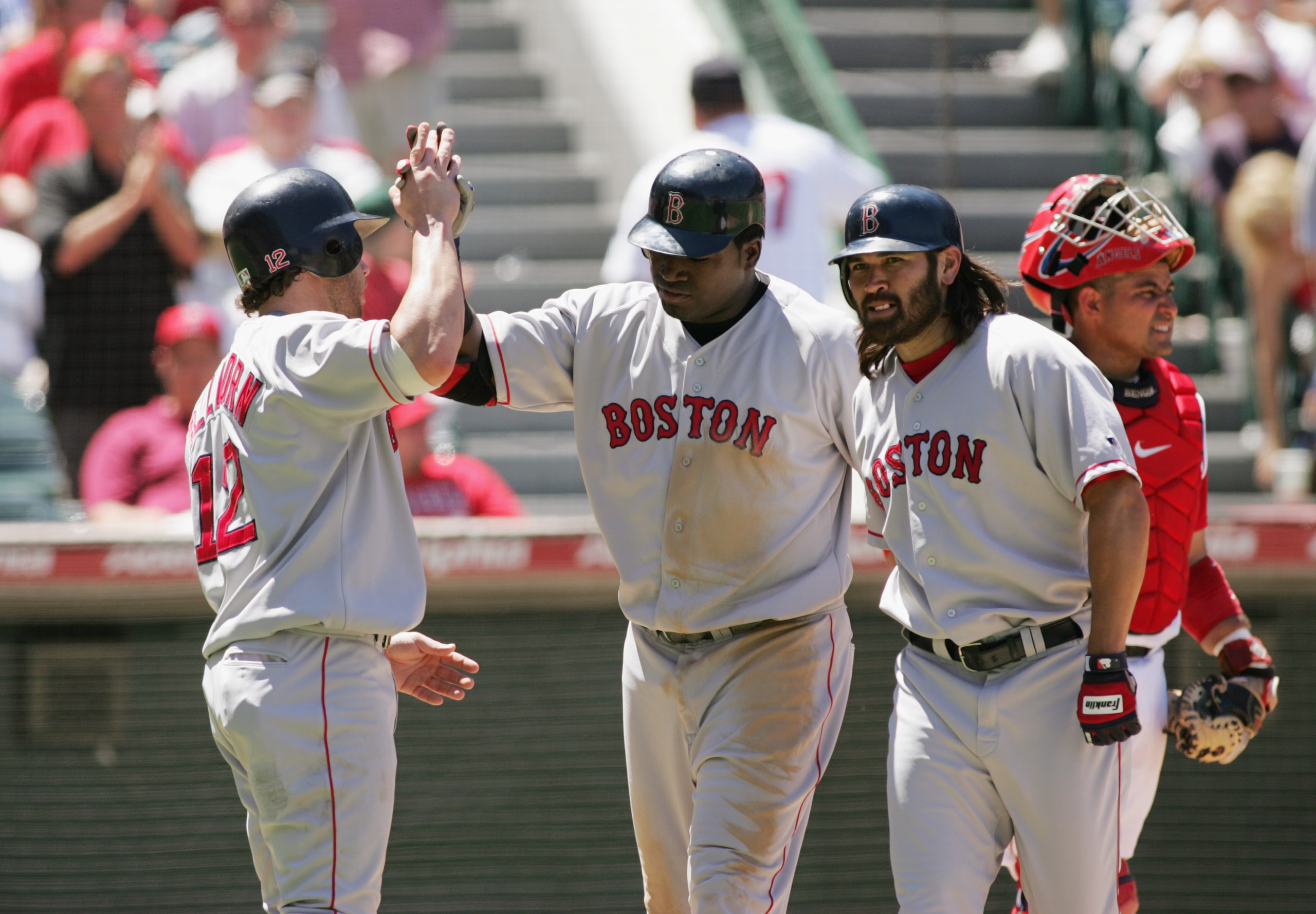 ANAHEIM, CA - JULY 18:  Mark Bellhorn #12 of the Boston Red Sox congratulates teammates David Ortiz #34 and Johnny Damon #18 (right) after Ortiz hit a three-run home during the game against the Anaheim Angels at the Angel Stadium on July 18, 2004 in Anahe