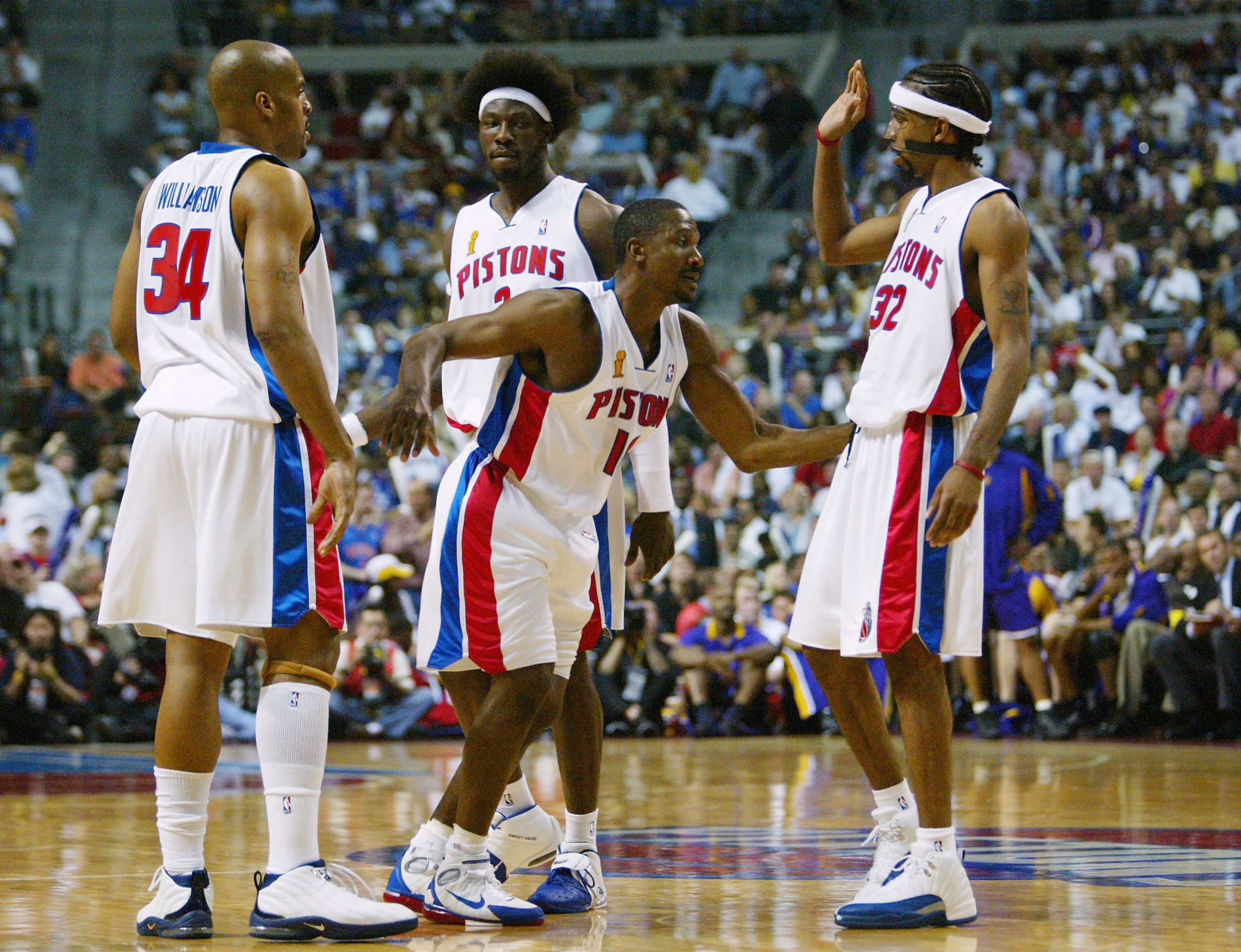 AUBURN HILLS, MI - JUNE 13:  Lindsey Hunter #10 of the Detroit Pistons is helped up by his teammates Corliss Williamson #34, Ben Wallace #3 and Richard Hamilton #32 after being fouled by Luke Walton #4 of the Los Angeles Lakers during the second quarter i