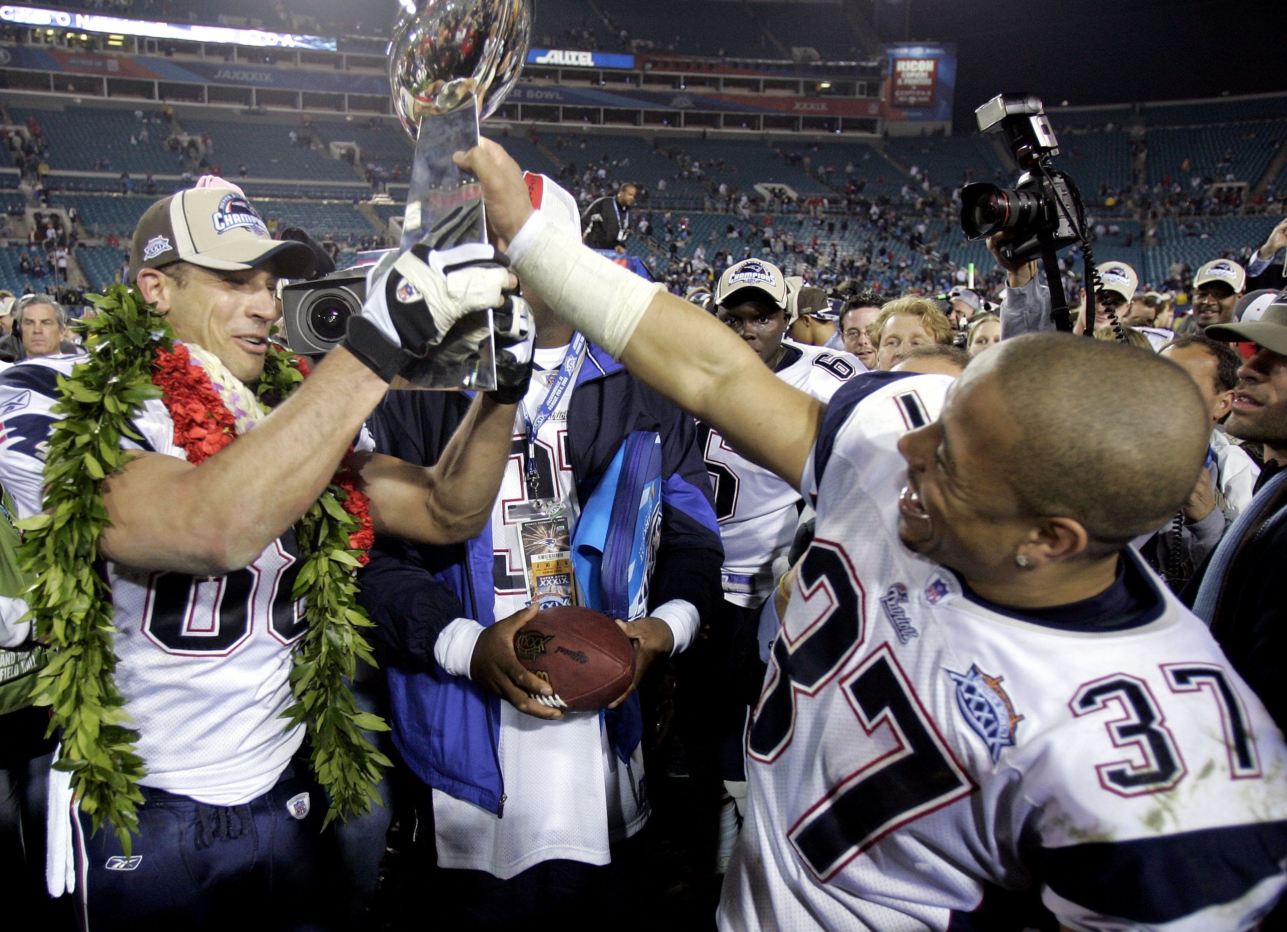 JACKSONVILLE, FL - FEBRUARY 6:  Rodney Harrison #37 and Christian Fauria #88 of the New England Patriots celebrate with the Lombardi Trophy after defeating the Philadelphia Eagles in Super Bowl XXXIX at Alltel Stadium on February 6, 2005 in Jacksonville,