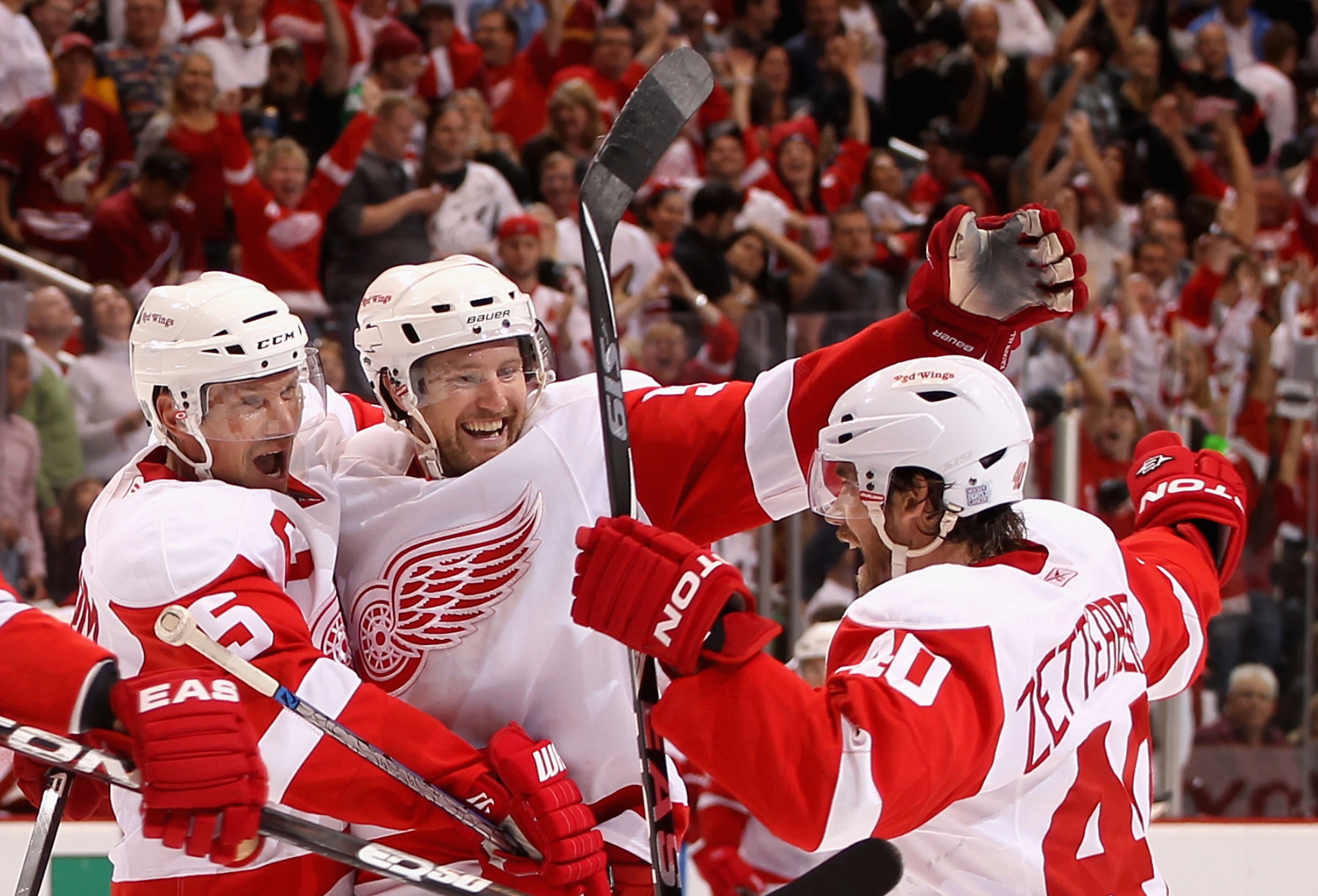 GLENDALE, AZ - OCTOBER 16:  Niklas Kronwall #55 of the Detroit Red Wings celebrates with teammates Nicklas Lidstrom #5 and Henrik Zetterberg #40 after Kronwall scored the game winning power play goal in overtime against the Phoenix Coyotes during the NHL