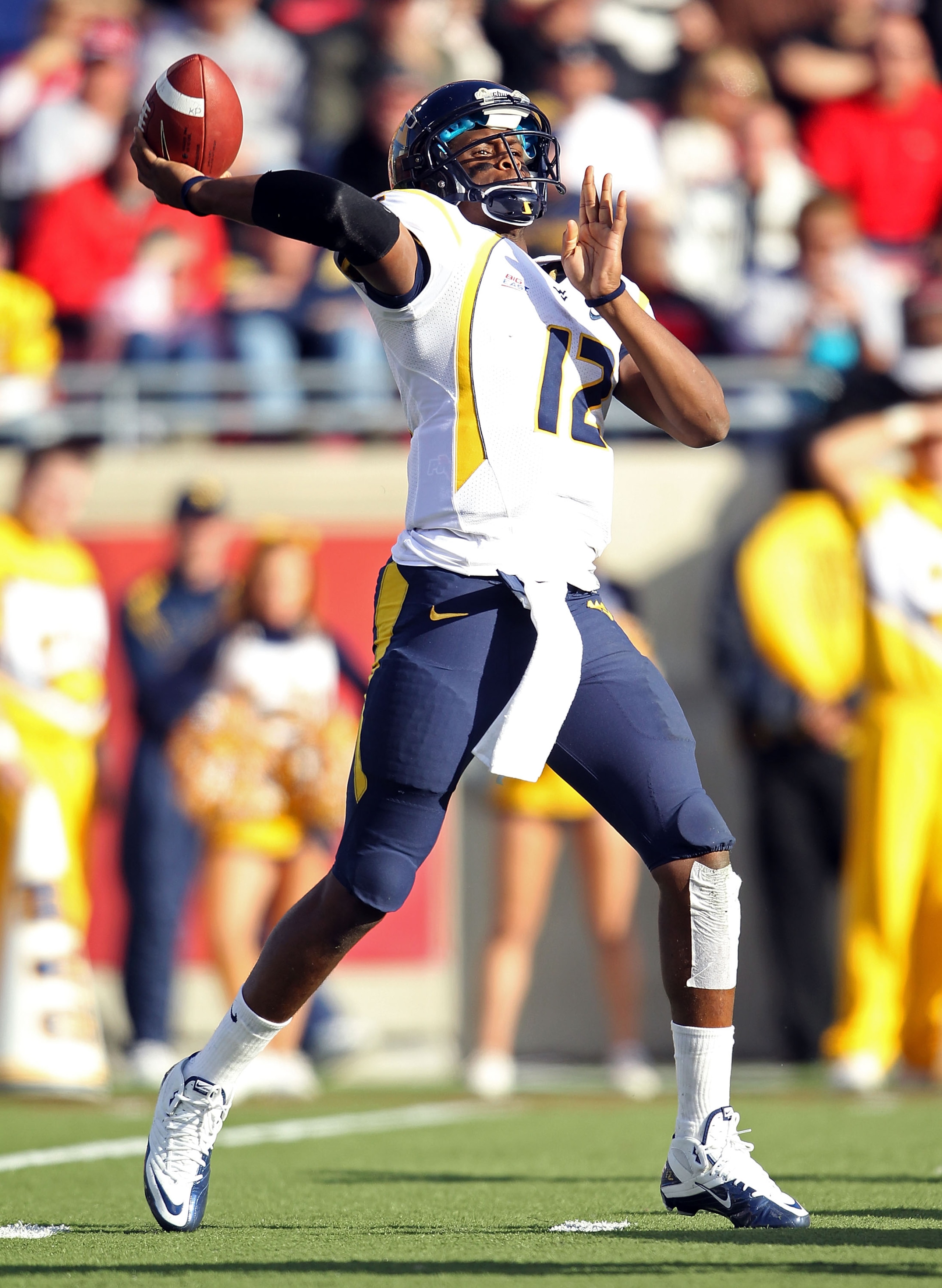 LOUISVILLE, KY - NOVEMBER 20:  Geno Smith#12 of the West Virginia Mountaineers throws a pass during the Big East Conference game against the Louisville Cardinals at Papa John's Cardinal Stadium on November 20, 2010 in Louisville, Kentucky.  (Photo by Andy