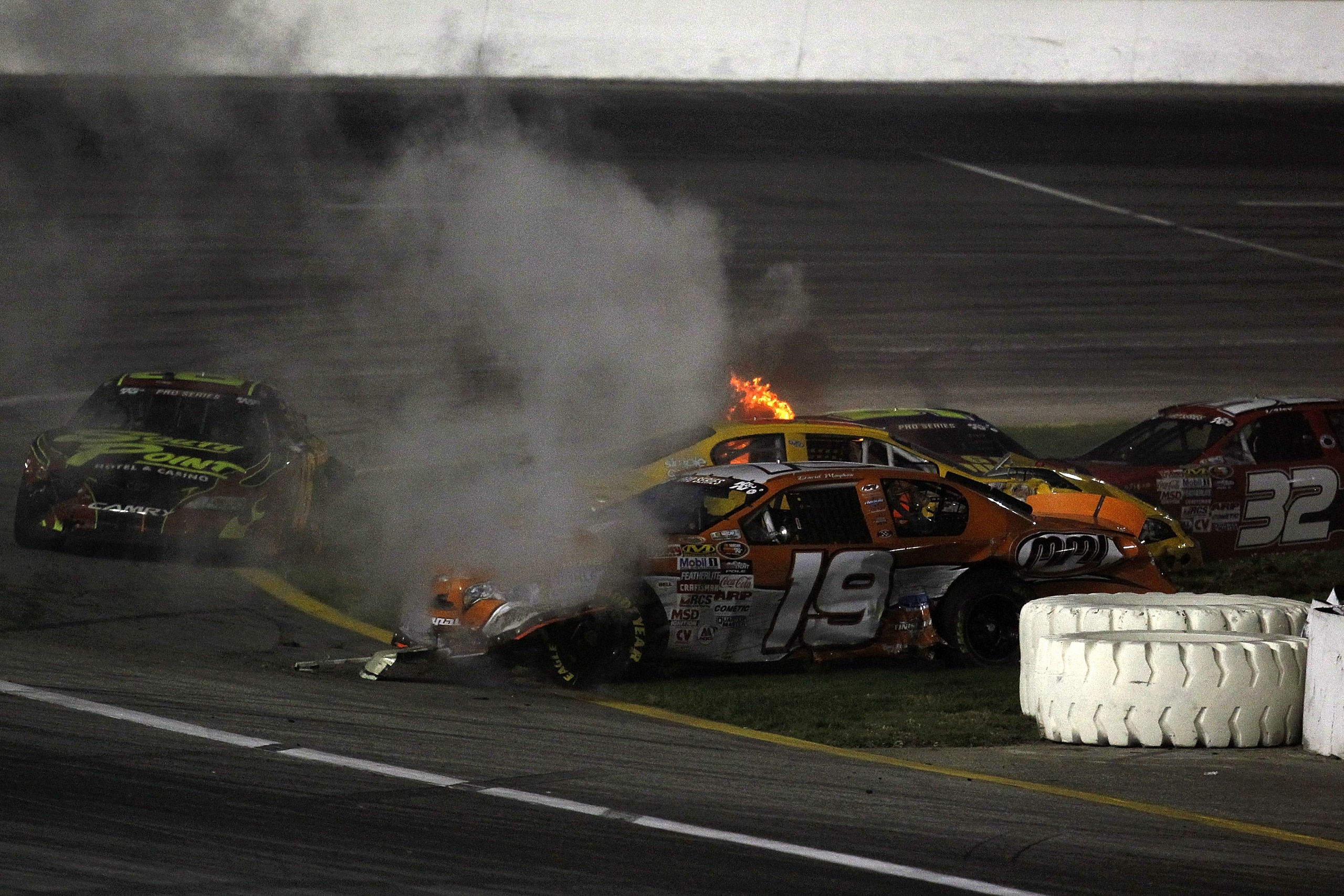 IRWINDALE, CA - JANUARY 29:  David Mayhew, driver of the #19 MMI/Ron's Rear Ends/KHI Chevrolet, Steve Wallace, driver of the #66 South Point Hotel & Casino Toytoa, and Dale Quarterly, driver of the #32 Van Dyk Baler Chevrolet, are involved in a multi-car