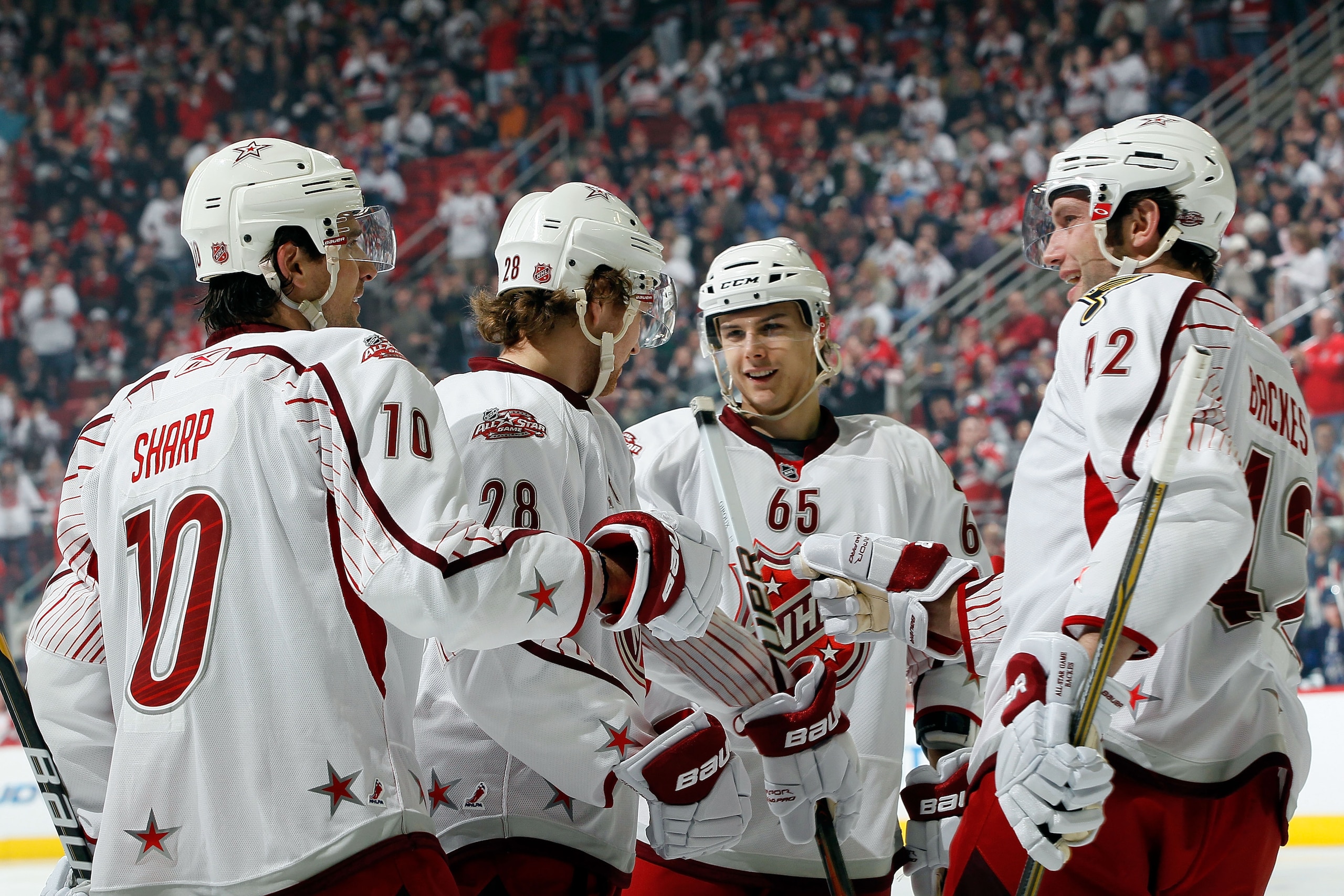 RALEIGH, NC - JANUARY 30:  Team Staal players Patrick Sharp #10 of the Chicago Blackhaws, Claude Giroux #28 of the Philadelphia Flyers, Erik Karlsson #65 of the Ottowa Senators and Eric Staal #12 of the Carolina Hurricanes react against Team Lidstrom duri