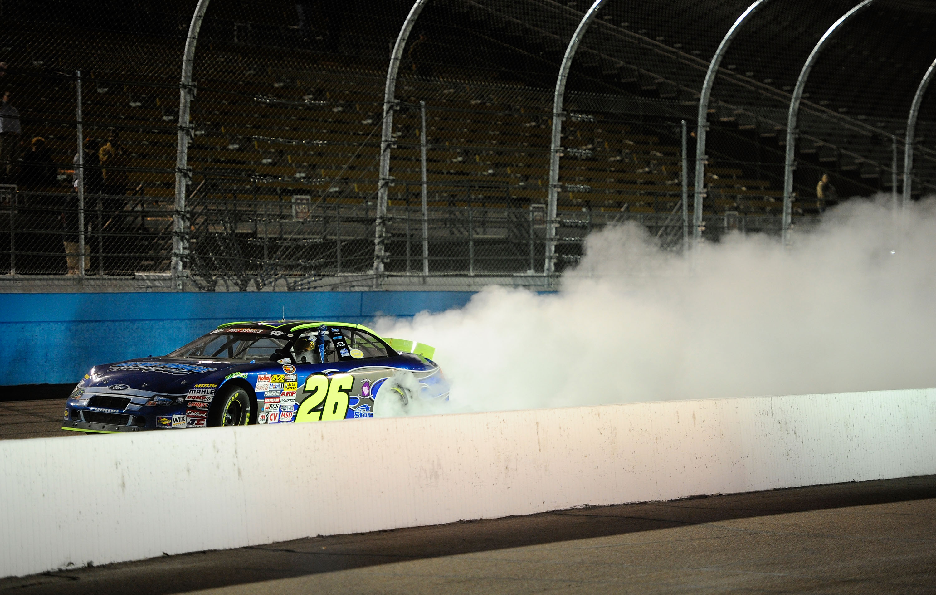 AVONDALE, AZ - NOVEMBER 13:  Greg Pursley #26 celebrates with a burnout after winning the NASCAR K&N Pro Series 3 Amigos Tequila 125 at Phoenix International Raceway on November 13, 2010 in Avondale, Arizona.  (Photo by Robert Laberge/Getty Images for NAS