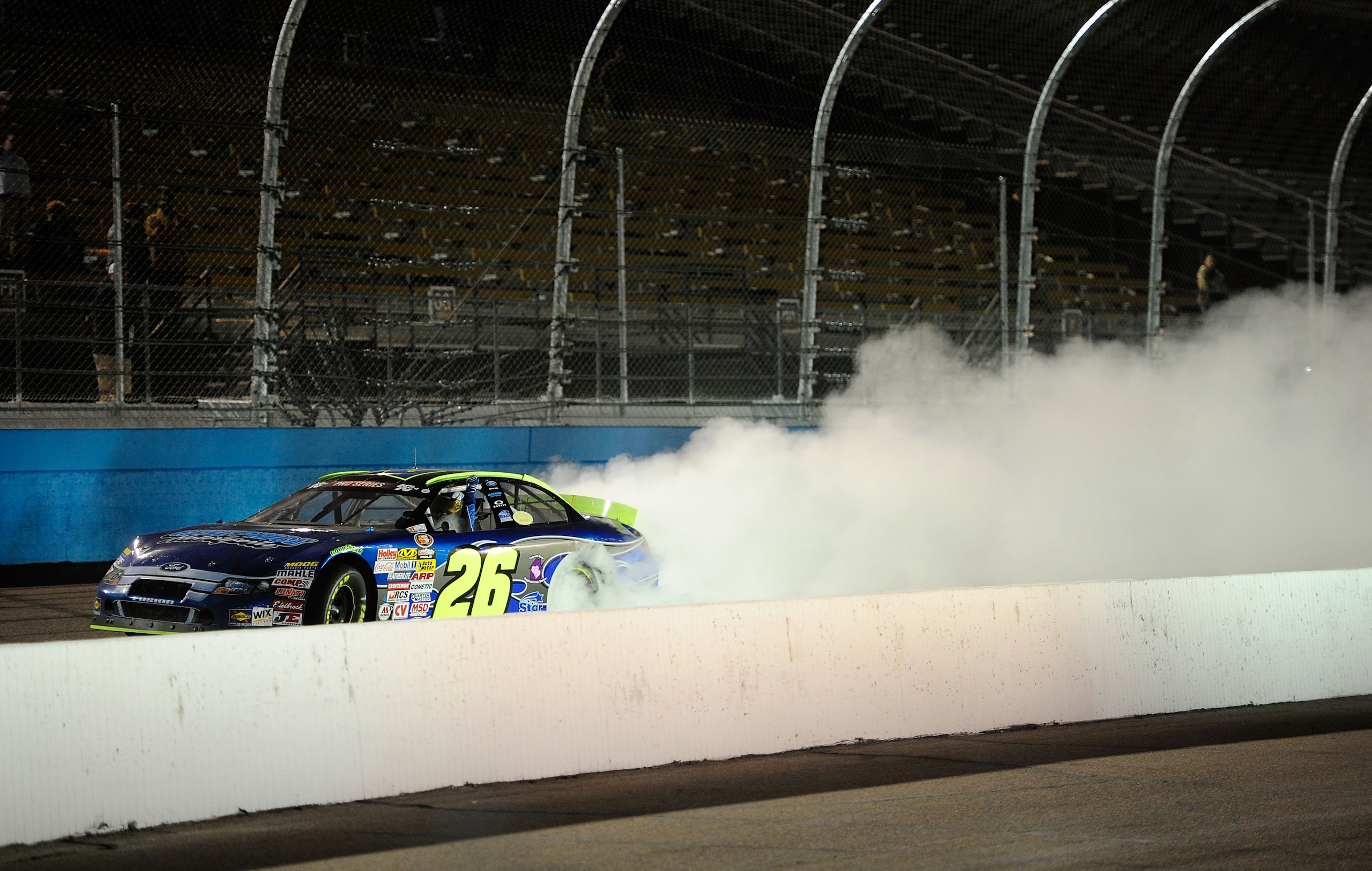 AVONDALE, AZ - NOVEMBER 13:  Greg Pursley #26 celebrates with a burnout after winning the NASCAR K&N Pro Series 3 Amigos Tequila 125 at Phoenix International Raceway on November 13, 2010 in Avondale, Arizona.  (Photo by Robert Laberge/Getty Images for NAS