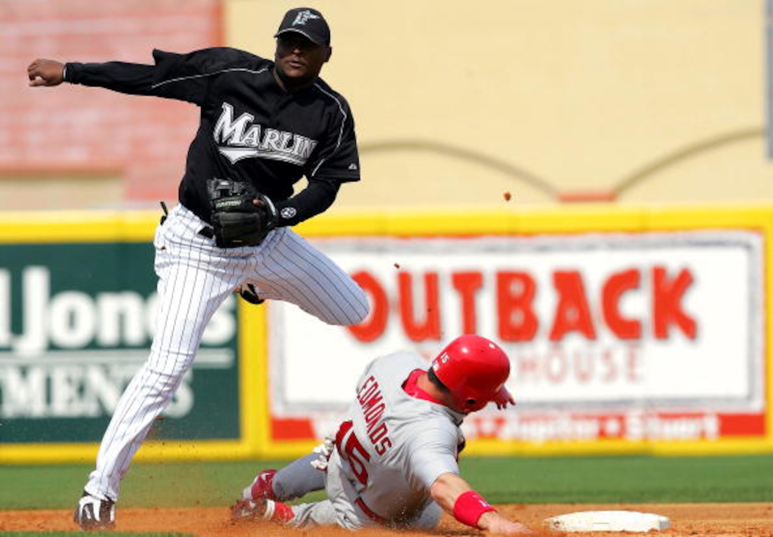 JUPITER, FL - MARCH 6:  Second baseman Luis Castillo #1 of the Florida Marlins turns the double play on the slide by Jim Edmonds #15 of the St. Louis Cardinals during MLB Spring Training action on March 6, 2005 at Robert Dean Stadium in Jupiter, Florida.