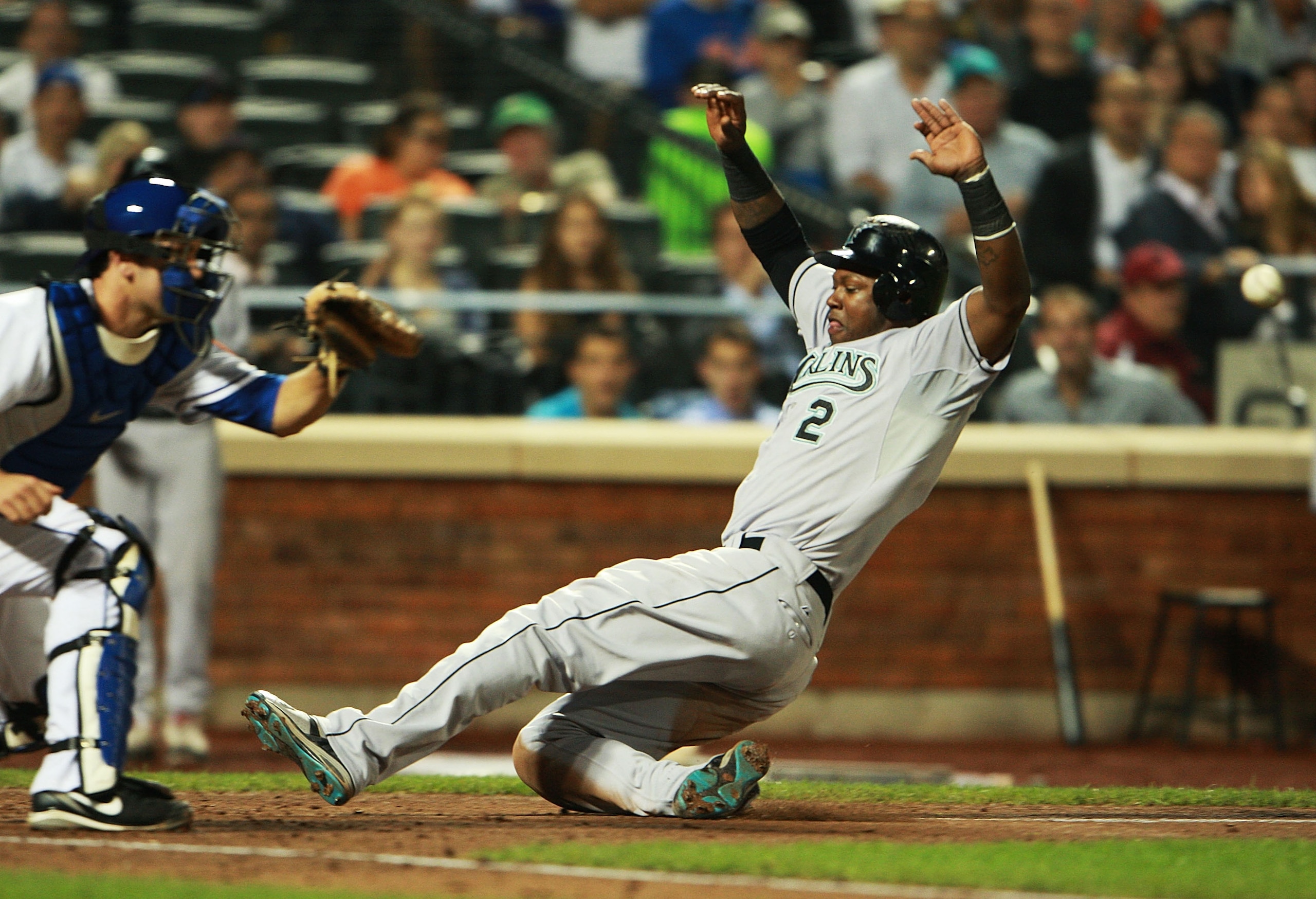 NEW YORK - AUGUST 25:  Hanley Ramirez #2 of the Florida Marlins successfully slides into home off of Gaby Sanchez's #14 (not shown) sacrifice fly in the third inning on August 25, 2010 at Citi Field in the Flushing neighborhood of the Queens borough of Ne