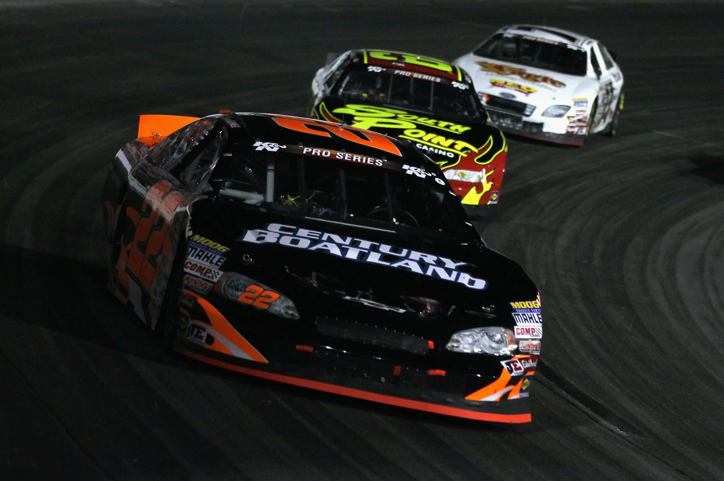 IRWINDALE, CA - JANUARY 29:  Jonathon Gomez driver of the #22 Century Boatland Chevrolet leads a pack of cars into a turn during the NASCAR Toyota All-Star Showdown at Toyota Speedway at Irwindale on January 29, 2011 in Irwindale, California.  (Photo by J