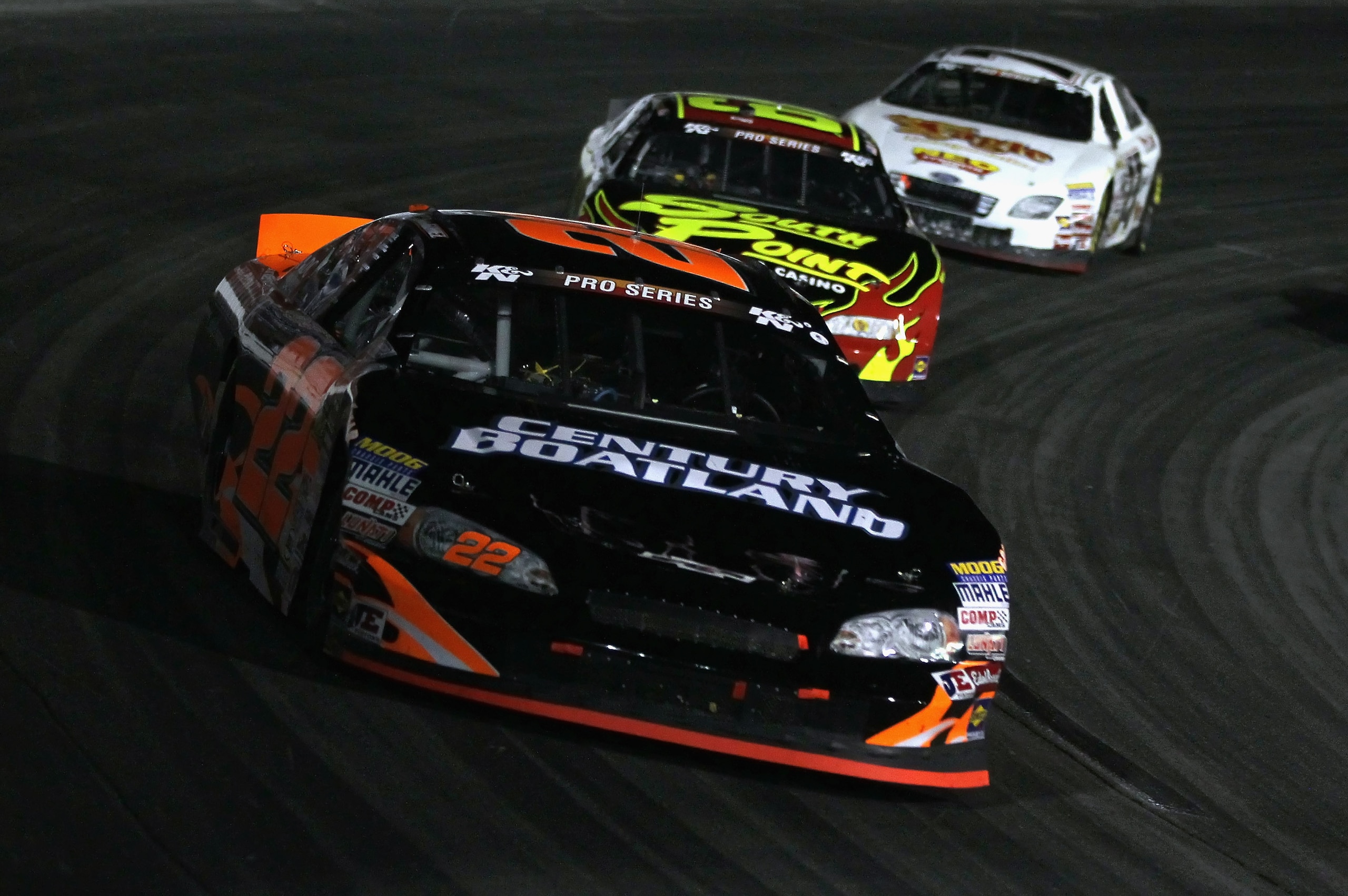 IRWINDALE, CA - JANUARY 29:  Jonathon Gomez driver of the #22 Century Boatland Chevrolet leads a pack of cars into a turn during the NASCAR Toyota All-Star Showdown at Toyota Speedway at Irwindale on January 29, 2011 in Irwindale, California.  (Photo by J