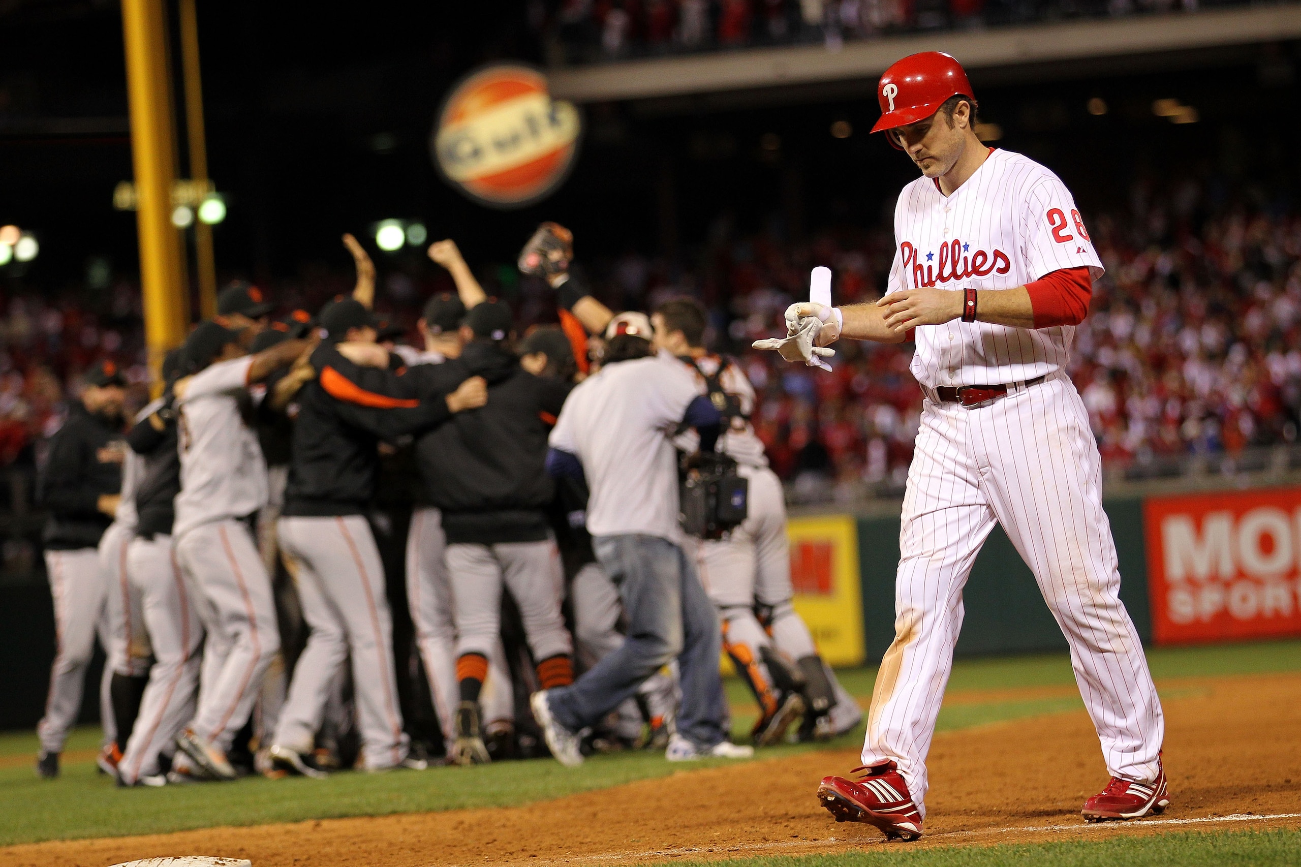 PHILADELPHIA - OCTOBER 23:  Chase Utley #26 of the Philadelphia Phillies walks off the field as the San Francisco Giants celebrate winning 3-2 to win the pennant in Game Six of the NLCS during the 2010 MLB Playoffs at Citizens Bank Park on October 23, 201