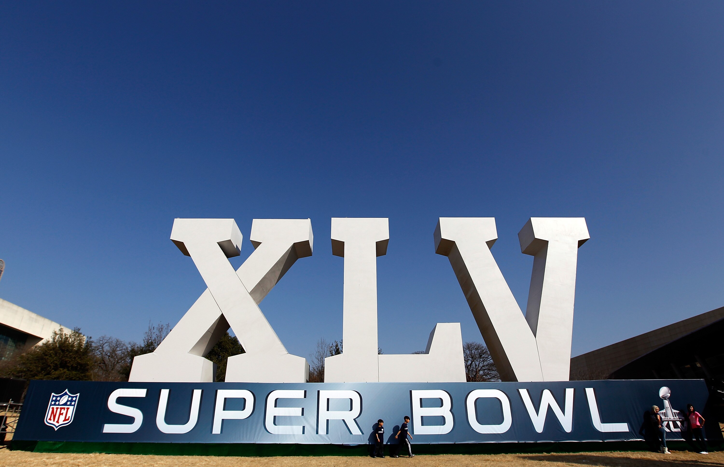 DALLAS, TX - JANUARY 30:  Football fans gather around a large Super Bowl XLV display on January 30, 2011 in downtown Dallas, Texas.  Cowboys Stadium will host Super Bowl XLV on February 6, 2011 between the Pittsburgh Steelers and the Green Bay Packers in