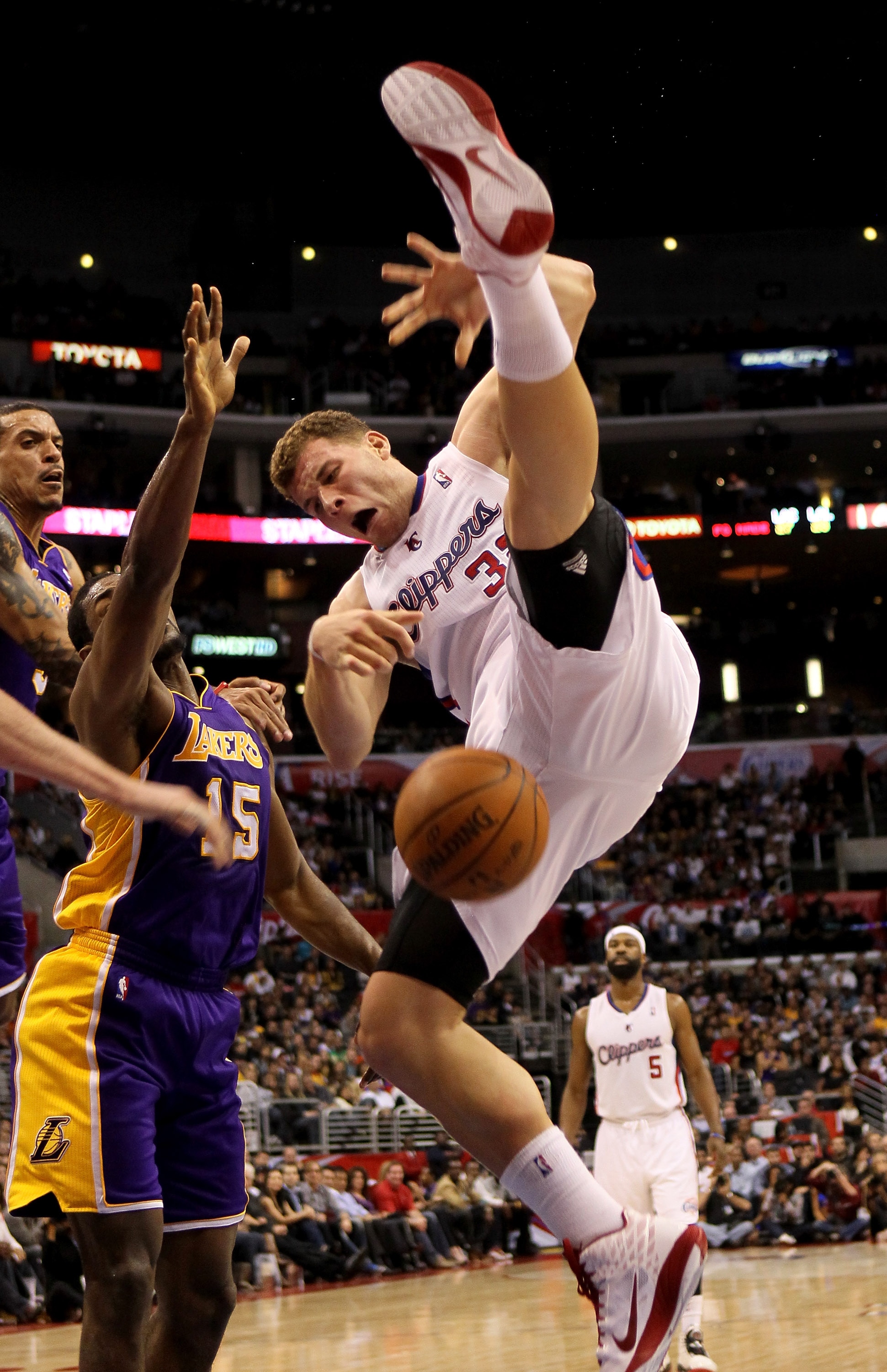 LOS ANGELES, CA - DECEMBER 08:  Blake Griffin #32 of the Los Angeles Clippers falls to the florr after being fouled by Matt Barnes 9 (L) of the Los Angeles Lakers as Ron Artest #15 also defends at Staples Center on December 8, 2010 in Los Angeles, Califor