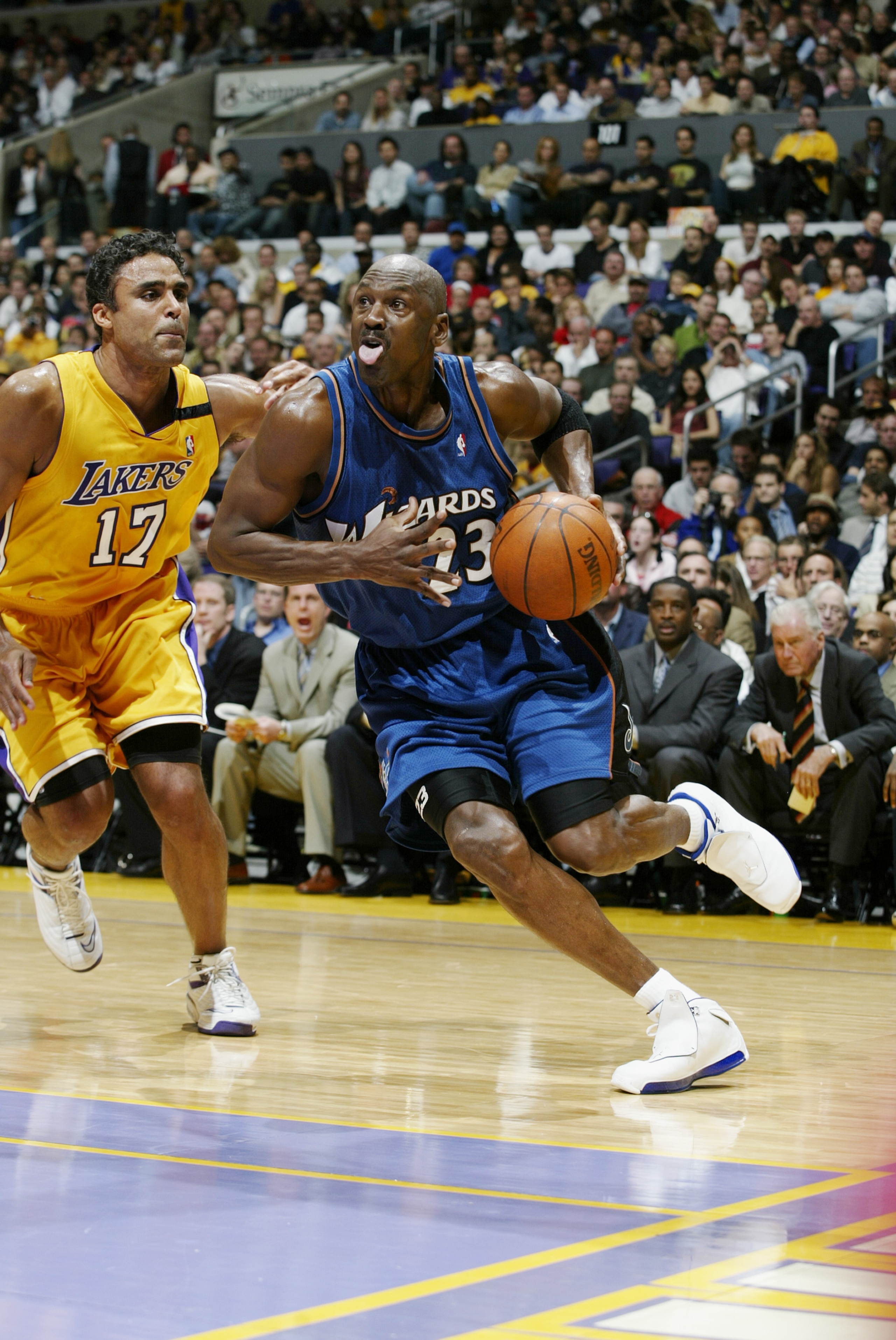 LOS ANGELES - MARCH 28: Michael Jordan #23 of the Washington Wizards drives past Rick Fox #17 of the Los Angeles Lakers during the game at Staples Center on March 28, 2003 in Los Angeles, California. The Lakers won 108-94. NOTE TO USER: User expressly LOS ANGELES - MARCH 28: Michael Jordan #23 of the Washington Wizards drives past Rick Fox #17 of the Los Angeles Lakers during the game at Staples Center on March 28, 2003 in Los Angeles, California. The Lakers won 108-94. NOTE TO USER: User expressly