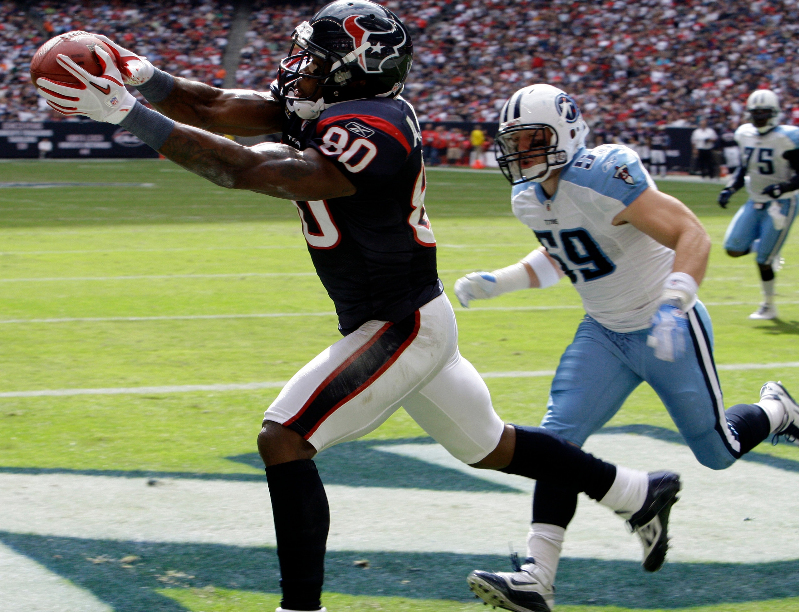 HOUSTON - NOVEMBER 28: Wide receiver Andre Johnson #80 of the Houston Texans completes a catch in the back of the endzone for a score as he was defended by linebacker Tim Shaw #59 of the Tennessee Titans at Reliant Stadium on November 28, 2010 in Housto HOUSTON - NOVEMBER 28: Wide receiver Andre Johnson #80 of the Houston Texans completes a catch in the back of the endzone for a score as he was defended by linebacker Tim Shaw #59 of the Tennessee Titans at Reliant Stadium on November 28, 2010 in Housto