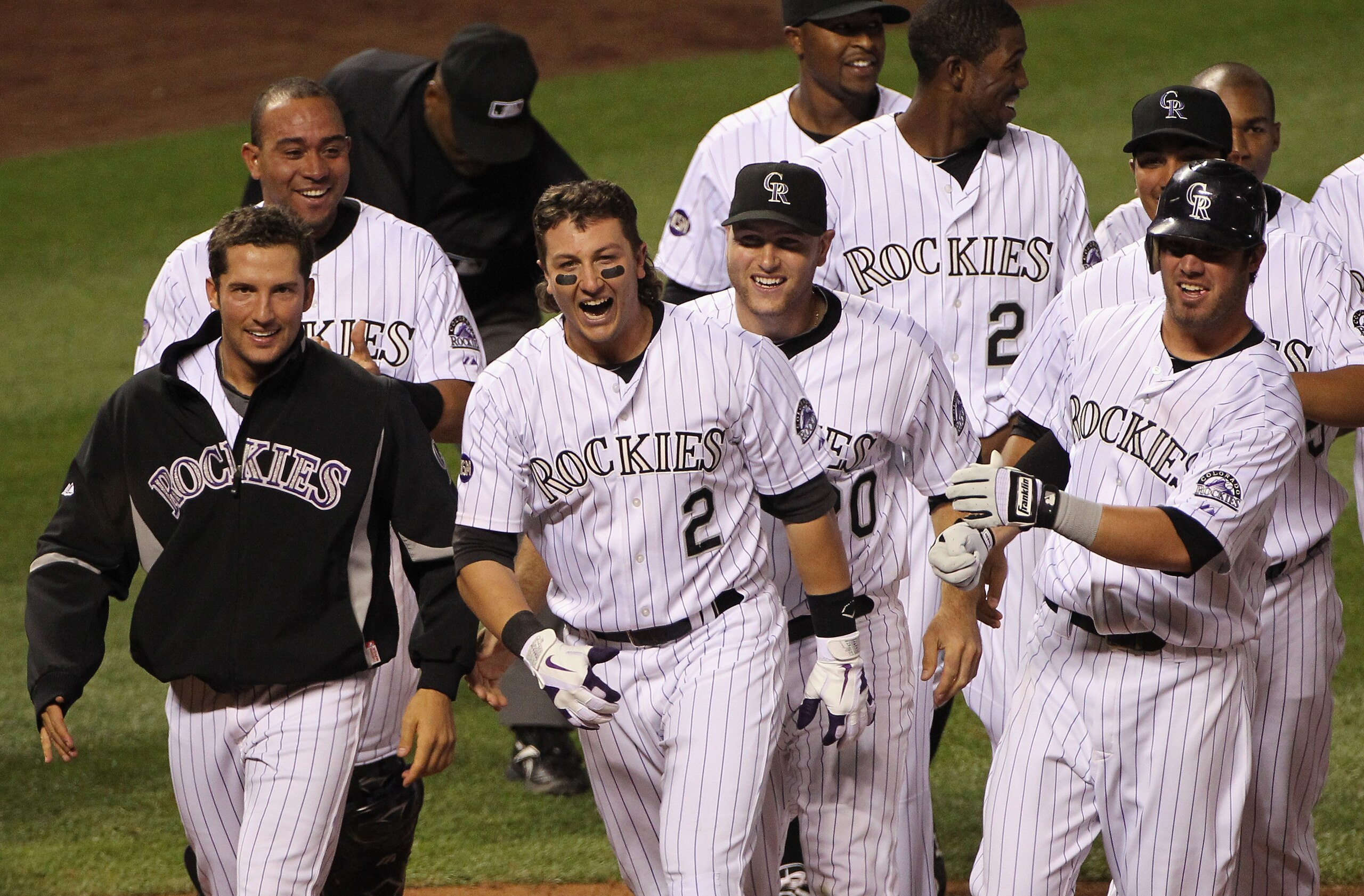 DENVER - SEPTEMBER 25: Troy Tulowitzki #2 of the Colorado Rockies celebrates with Huston Street (L) and their teammates after he hit the game RBI double to score Carlos Gonzalez #5 against the San Francisco Giants in the 10th inning at Coors Field on Sep DENVER - SEPTEMBER 25: Troy Tulowitzki #2 of the Colorado Rockies celebrates with Huston Street (L) and their teammates after he hit the game RBI double to score Carlos Gonzalez #5 against the San Francisco Giants in the 10th inning at Coors Field on Sep