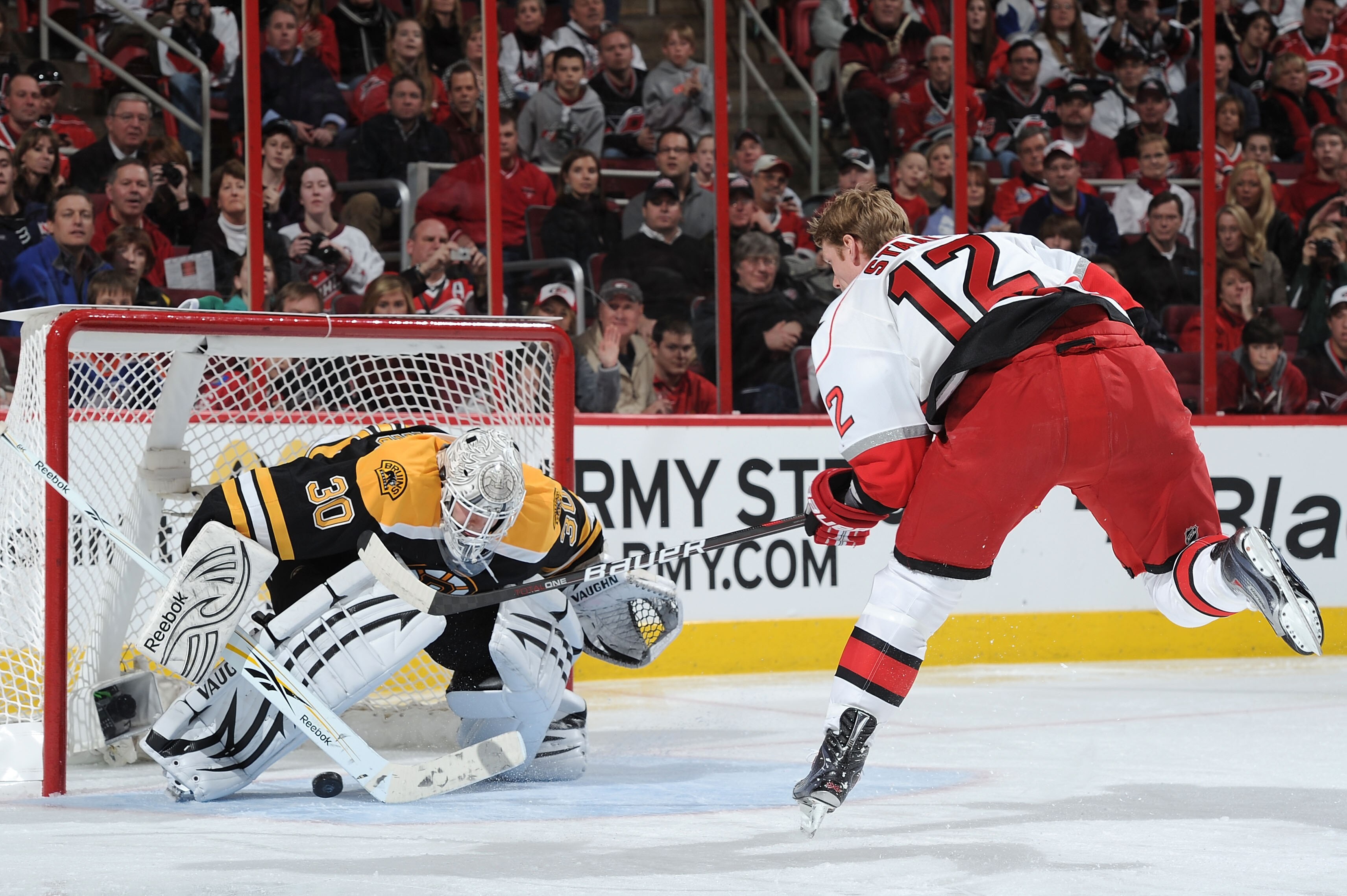 RALEIGH, NC - JANUARY 29:  Eric Staal #12 of the Carolina Hurricanes scores on Tim Thomas #30 of the Boston Bruins during the eliminatin shootout of the Honda NHL SuperSkills competition part of 2011 NHL All-Star Weekend at the RBC Center on January 29, 2