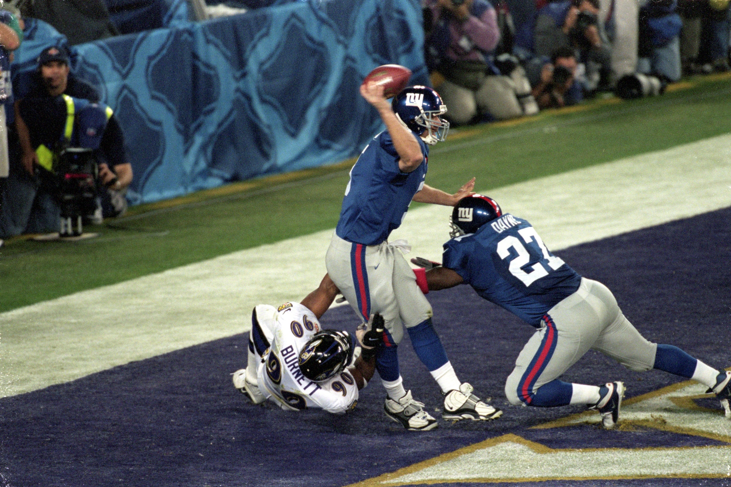 28 Jan 2001:  Quarterback Kerry Collins #5 of the New York Giants gets ready to pass the ball as teammate Ron Dayne #27 tries to hold back Bob Burnett #90 of the Baltimore Ravens during the Super Bowl XXXV Game at the Raymond James Stadium in Tampa, Flori