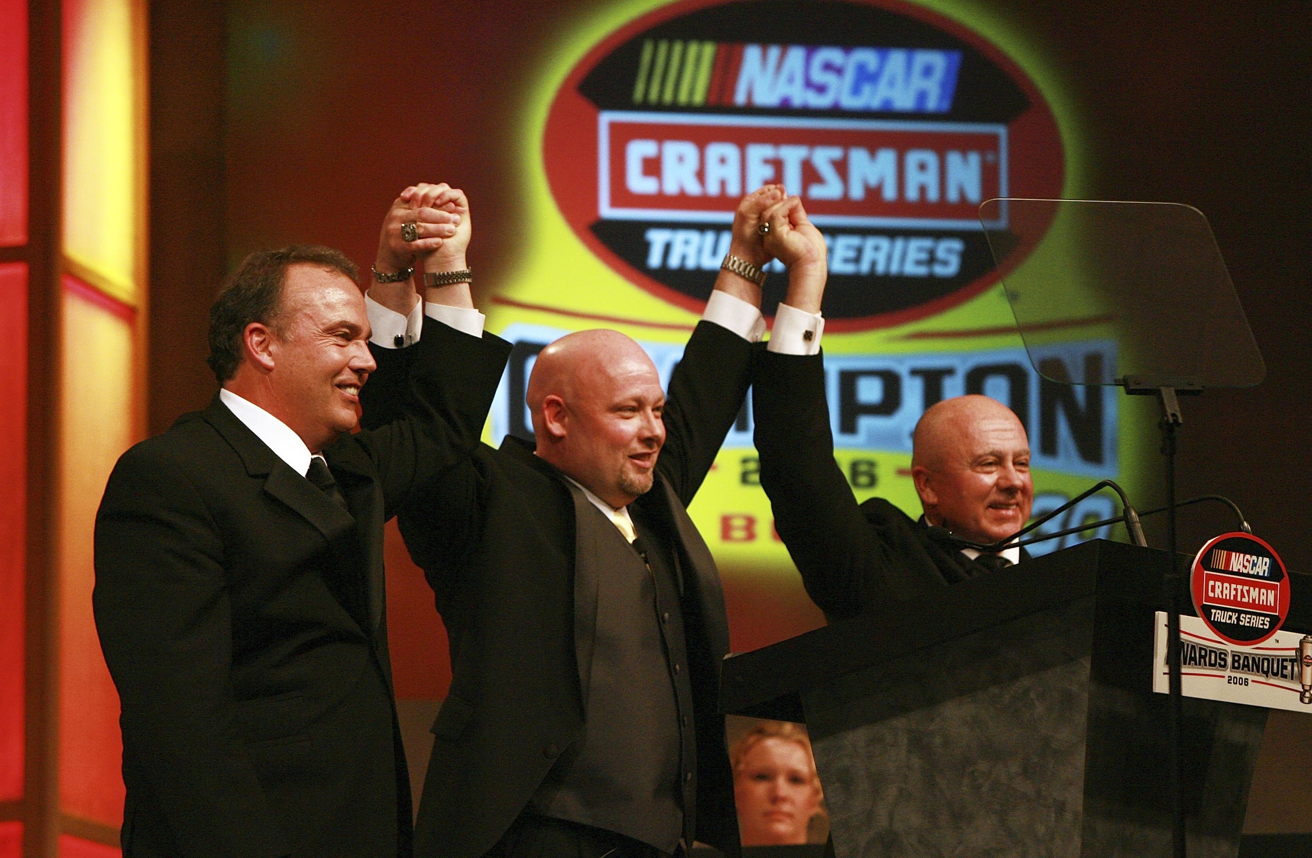 LAKE BUENA VISTA, FL - DECEMBER 10: Brothers Todd Bodine (C), Brett Bodine (L) and Geoffrey Bodine celebrate on stage during the NASCAR Craftsman Truck Series banquet at the Grand Floridian at Walt Disney World on December 10, 2006 in Lake Buena Vista, F LAKE BUENA VISTA, FL - DECEMBER 10: Brothers Todd Bodine (C), Brett Bodine (L) and Geoffrey Bodine celebrate on stage during the NASCAR Craftsman Truck Series banquet at the Grand Floridian at Walt Disney World on December 10, 2006 in Lake Buena Vista, F