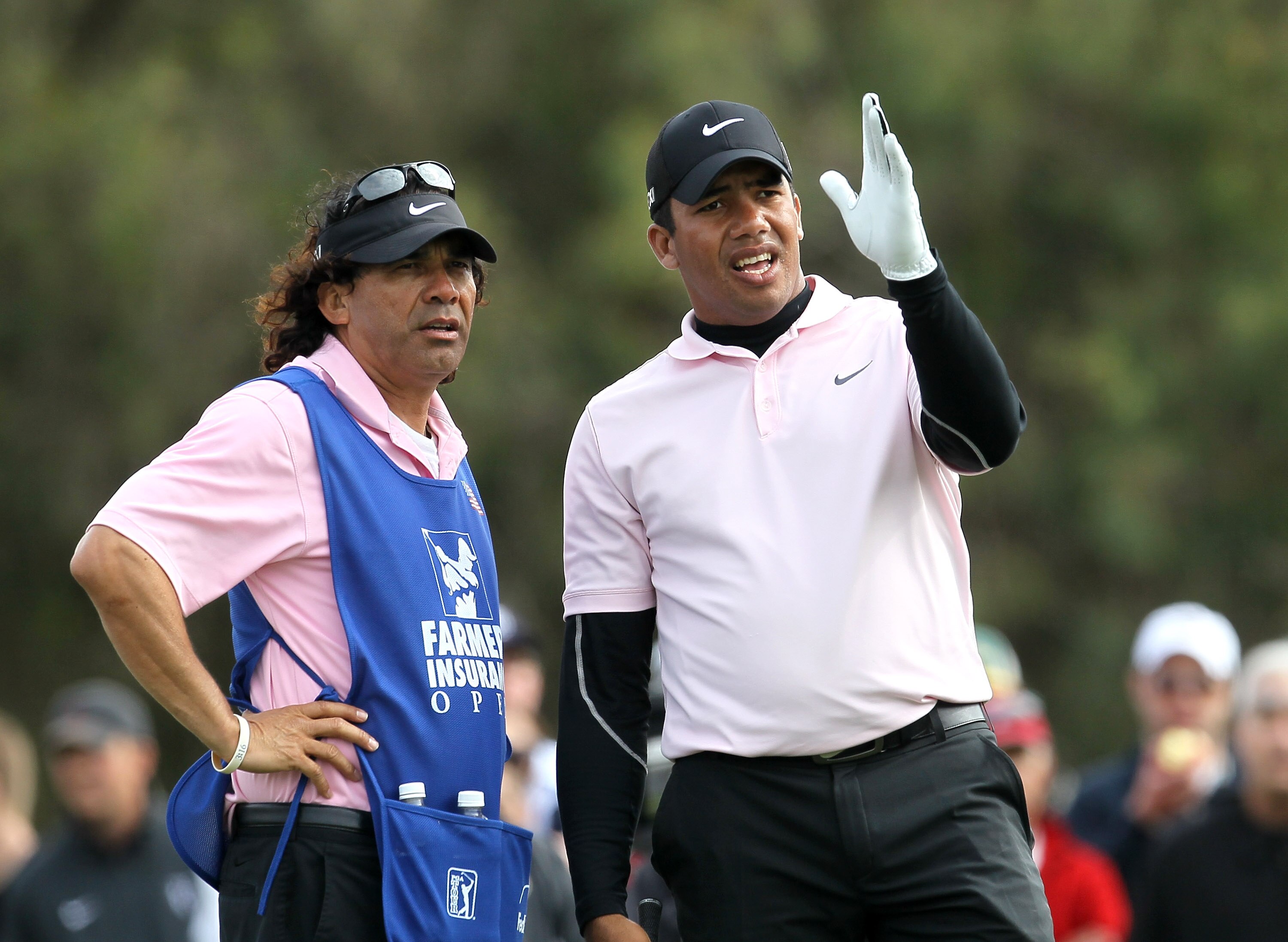 LA JOLLA, CA - JANUARY 30:  Jhonattan Vegas of Venzuelaand his caddie talk over his tee shot on the 12th hole during the final round of the Farmers Insurance Open at Torrey Pines South Course on January 30, 2011 in La Jolla, California.  (Photo by Stephen