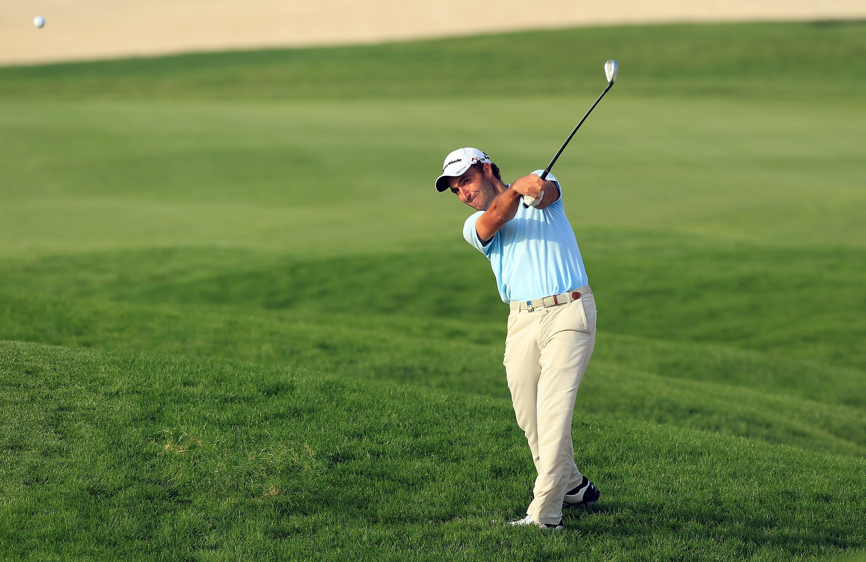 BAHRAIN, BAHRAIN - JANUARY 30:  Edoardo Molinari of Italy plays his second shot at the 18th hole during the final round of the 2011 Volvo Champions held at the Royal Golf Club on January 30, 2011 in Bahrain, Bahrain.  (Photo by David Cannon/Getty Images)