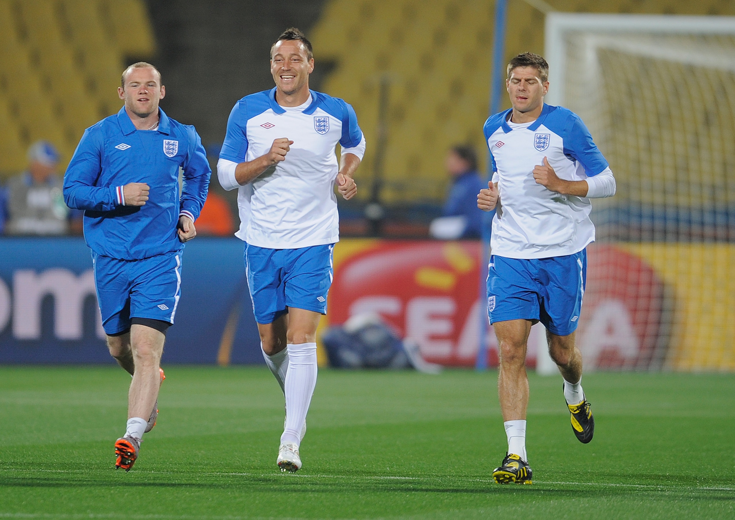 RUSTENBURG, SOUTH AFRICA - JUNE 11:  Wayne Rooney and John Terry share a joke as Steven Gerrard looks on during the England training session at the Royal Bafokeng Stadium on June 11, 2010 in Rustenburg, South Africa.  (Photo by Michael Regan/Getty Images)