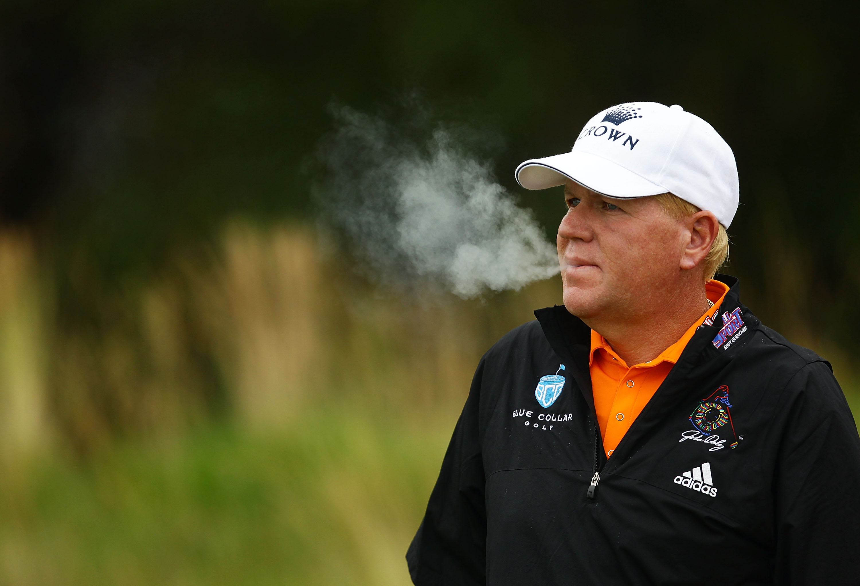 SYDNEY, AUSTRALIA - DECEMBER 02:  John Daly of the USA smokes a cigarette during day one of the Australian Open at The Lakes Golf Club on December 2, 2010 in Sydney, Australia.  (Photo by Matt King/Getty Images)