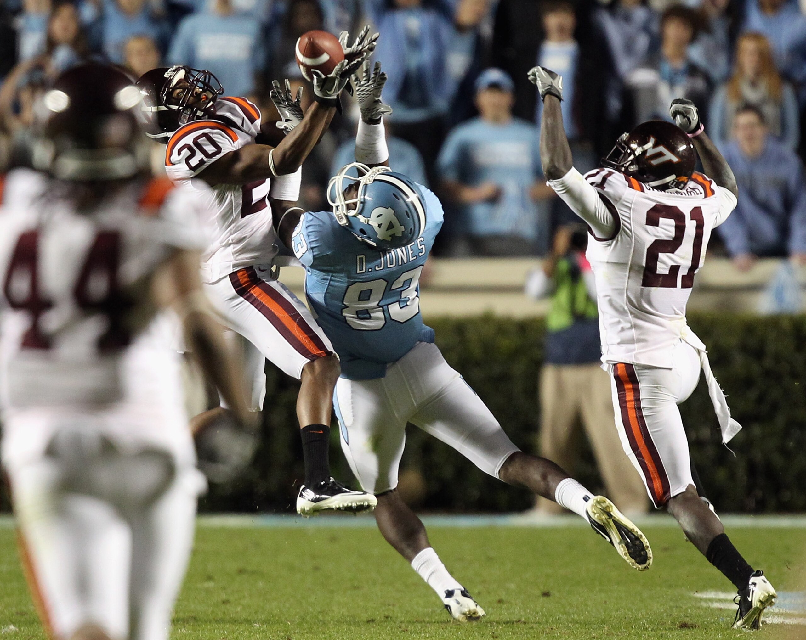 CHAPEL HILL, NC - NOVEMBER 13: Jayron Hosley #20 of the Virginia Tech Hokies makes an interception as teammate Rashad Carmichael #21 watches on with Dwight Jones #83 of the North Carolina Tar Heels during their game at Kenan Stadium on November 13, 2010 CHAPEL HILL, NC - NOVEMBER 13: Jayron Hosley #20 of the Virginia Tech Hokies makes an interception as teammate Rashad Carmichael #21 watches on with Dwight Jones #83 of the North Carolina Tar Heels during their game at Kenan Stadium on November 13, 2010