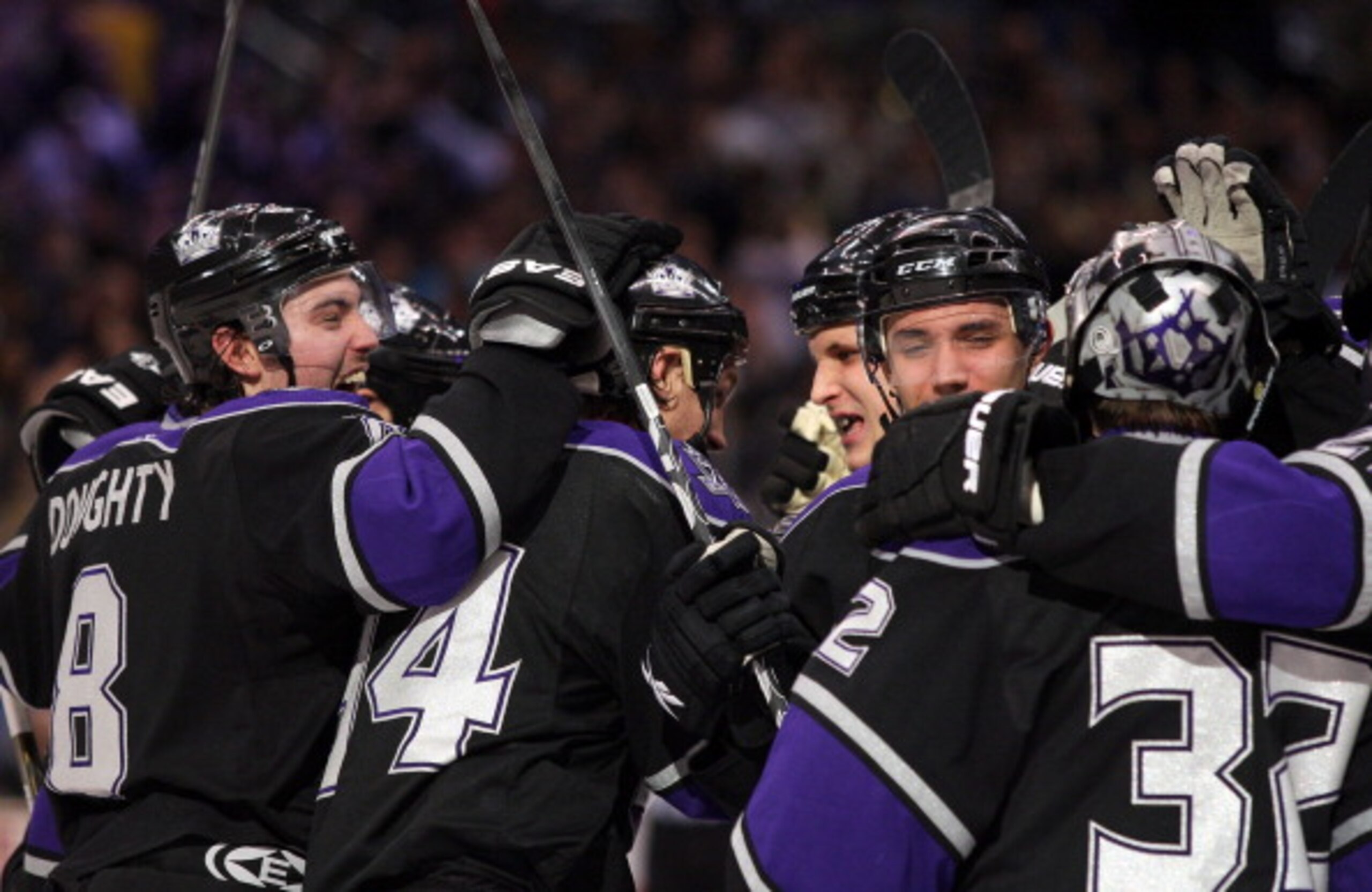LOS ANGELES, CA - JANUARY 26:  (L-R)Drew Doughty #8, Ryan Smyth #94, Kyle Clifford #13 and Alec Martinez #53 and goaltender Jonathan Quick #32 of the Los Angeles Kings celebrate after defeating the San Jose Sharks 3-2 in shootout overtime at Staples Cente