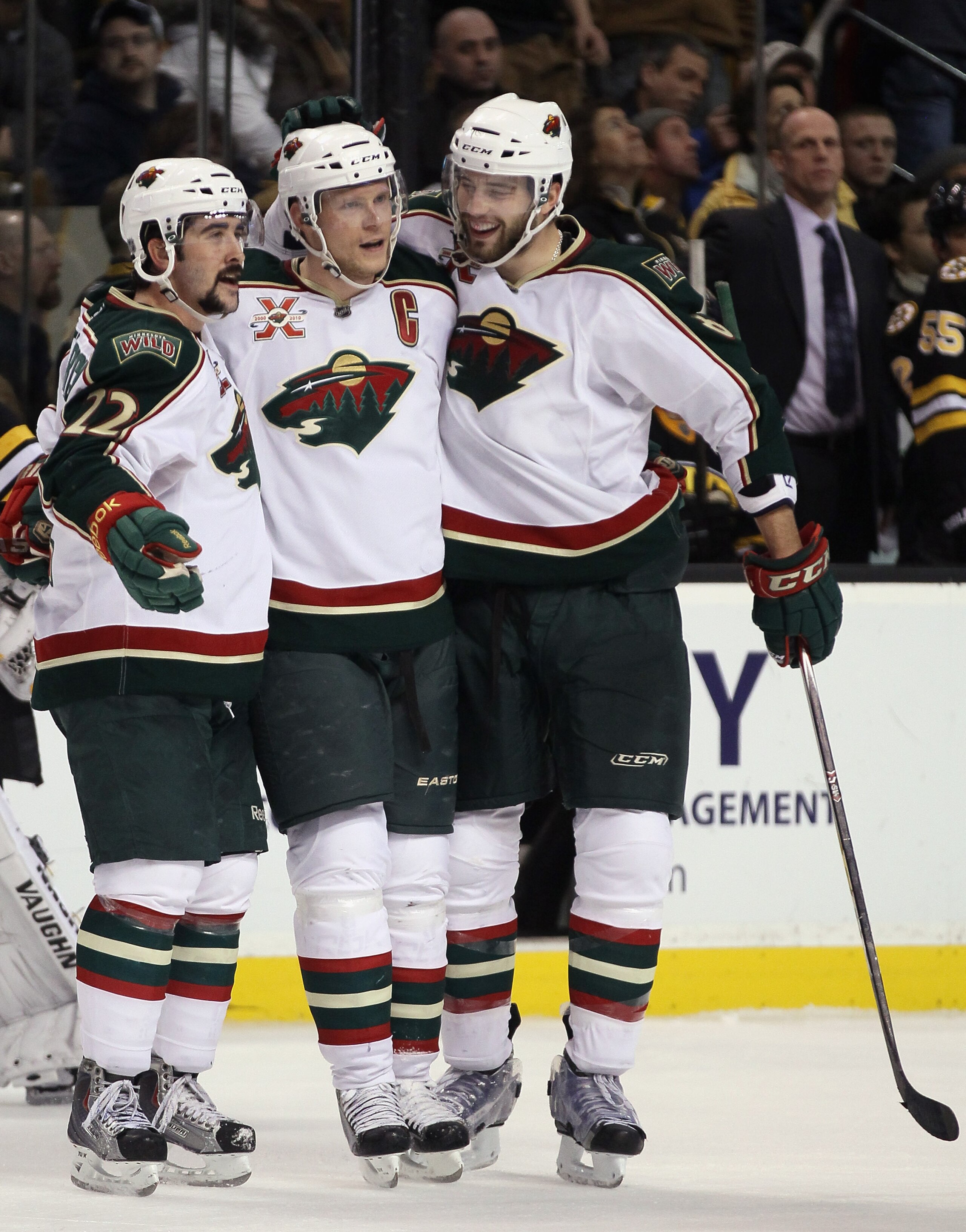 BOSTON, MA - JANUARY 06:  Mikko Koivu #9 of the Minnesota Wild is congratulated by teammates Cal Clutterbuck #22 and Brent Burns #8 after Koivu scored the empty net goal against the Boston Bruins on January 6, 2010 at the TD Garden in Boston, Massachusett