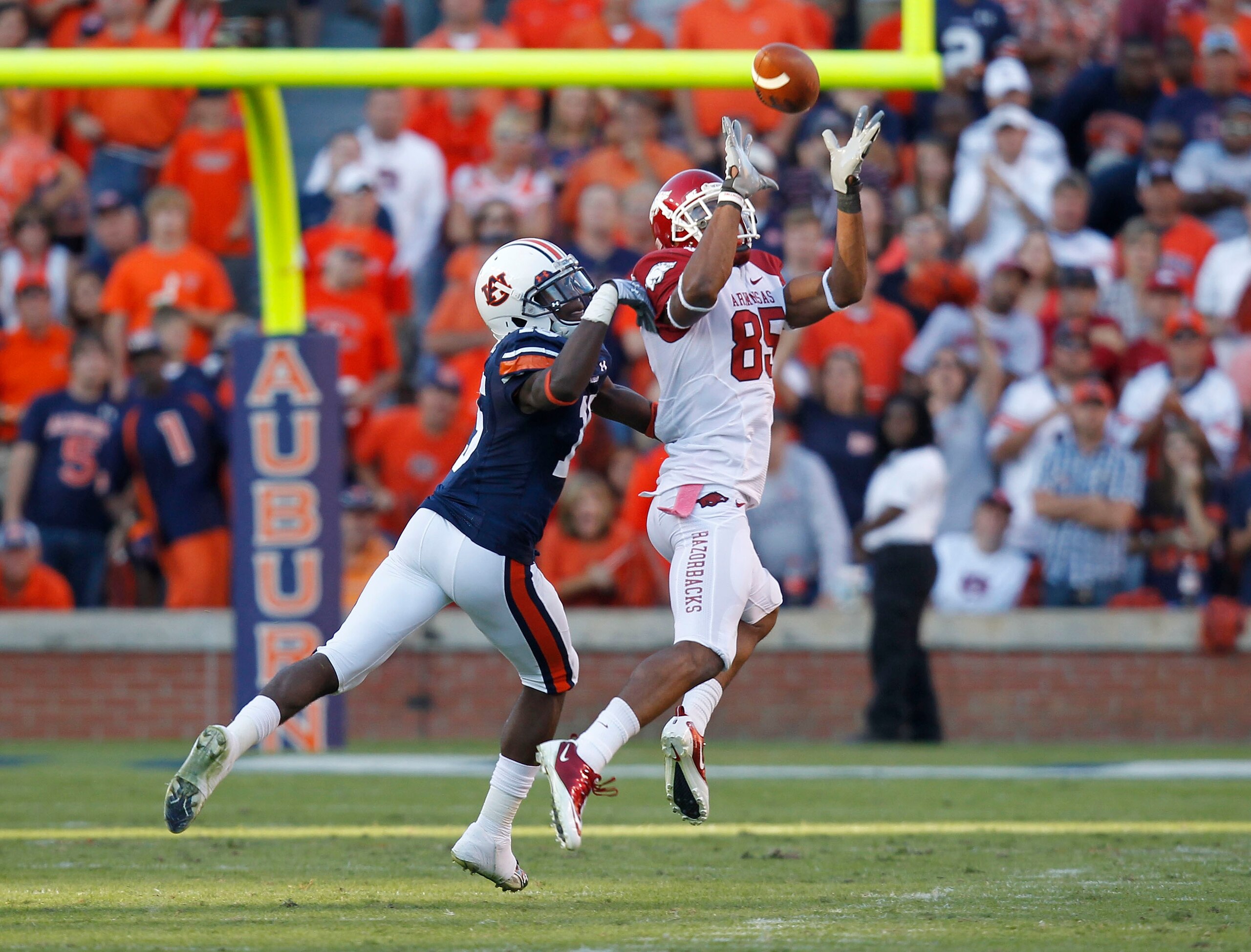 AUBURN - OCTOBER 16: Wide receiver Greg Childs #85 of the Arkansas Razorbacks catches a pass behind defensive back Neiko Thorpe #15 of the Auburn Tigers during the game at Jordan-Hare Stadium on October 16, 2010 in Auburn, Alabama. The Tigers beat the R AUBURN - OCTOBER 16: Wide receiver Greg Childs #85 of the Arkansas Razorbacks catches a pass behind defensive back Neiko Thorpe #15 of the Auburn Tigers during the game at Jordan-Hare Stadium on October 16, 2010 in Auburn, Alabama. The Tigers beat the R