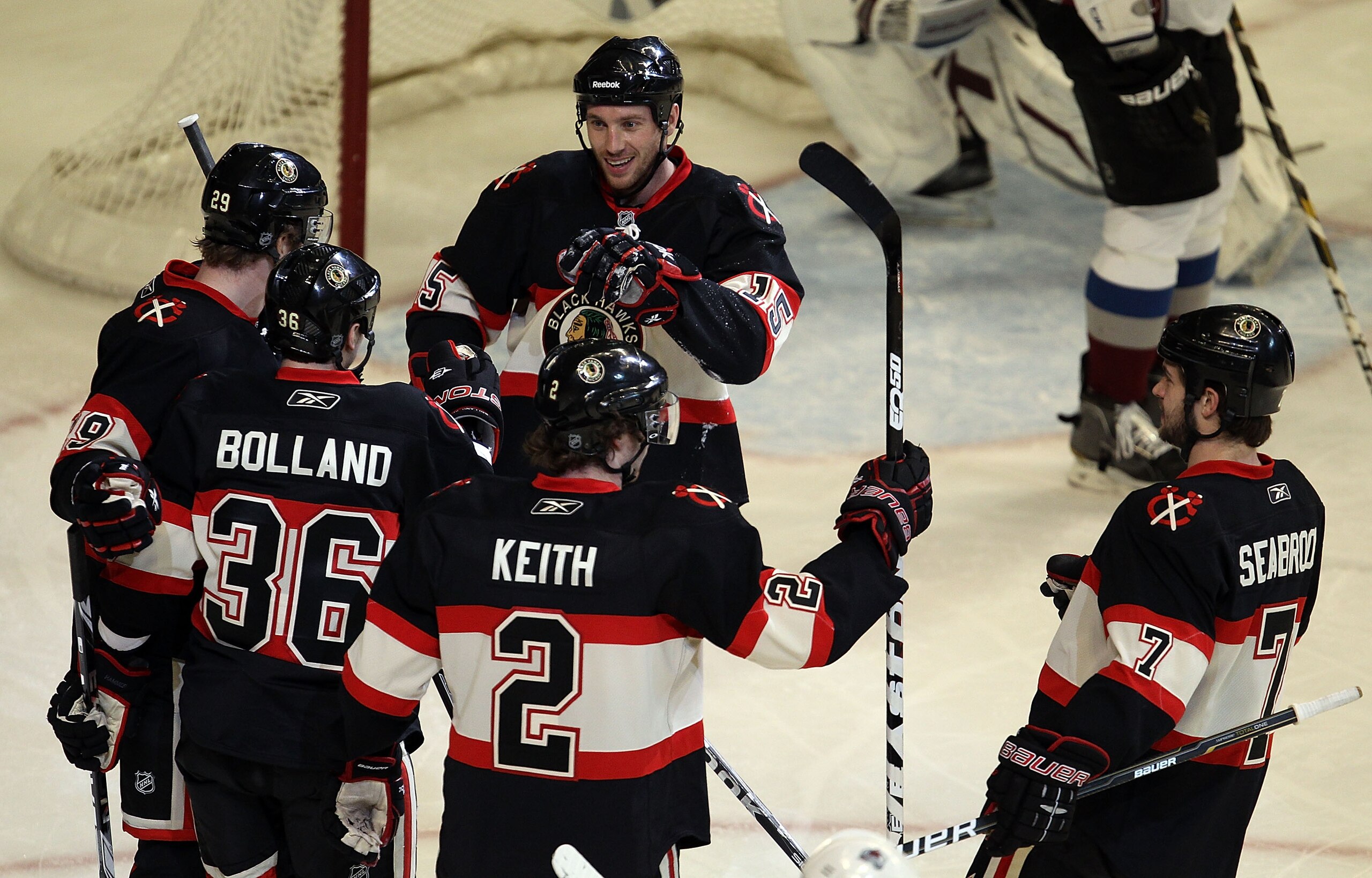 CHICAGO, IL - JANUARY 12: Dave Bolland #36 of the Chicago Blackhawks is congratulated after scoring a goal in the 1st period against the Colorado Avalanche by teammates (L-R) Jonathan Toews #19, Fernando Pisani #15, Duncan Keith #2 and Brent Seabrook #7 a