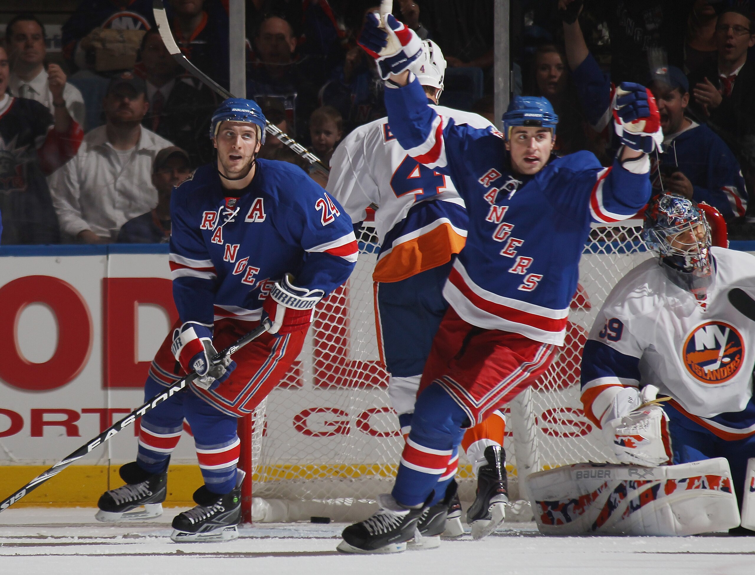 UNIONDALE, NY - OCTOBER 11: (L-R) Brandon Dubinsky #24 and Ryan Callahan #17 of the New York Rangers celebrate a power play goal by Michael Del Zotto (not shown) at 8:28 of the second period against the New York Islanders at the Nassau Coliseum on October