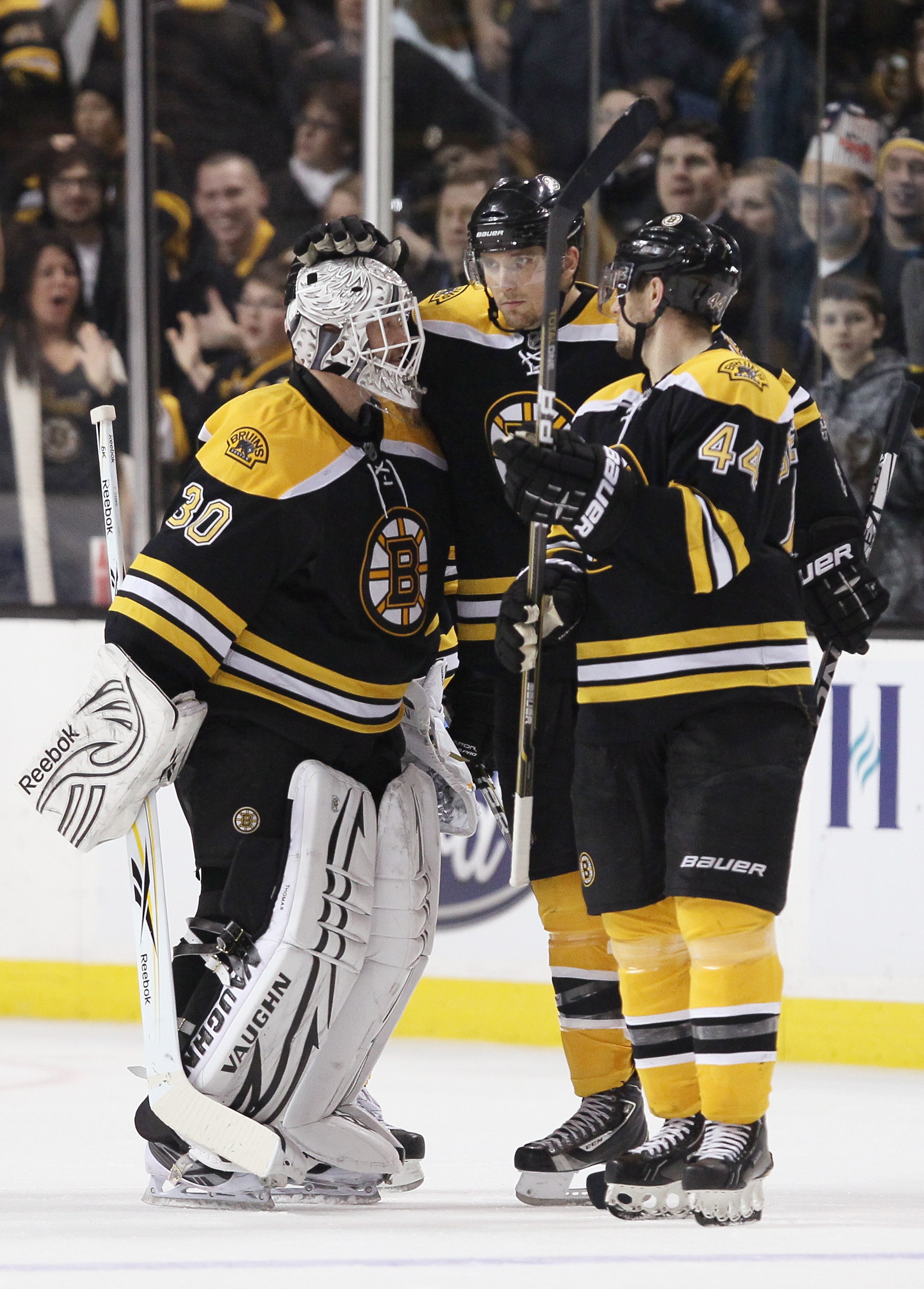 BOSTON, MA - JANUARY 11:  Tim Thomas #30 of the Boston Bruins celebrates the win with teammates Blake Wheeler #26 and Dennis Seidenberg #44 after the game against the Ottawa Senators on January 11, 2011 at the TD Garden in Boston, Massachusetts. The Bruin